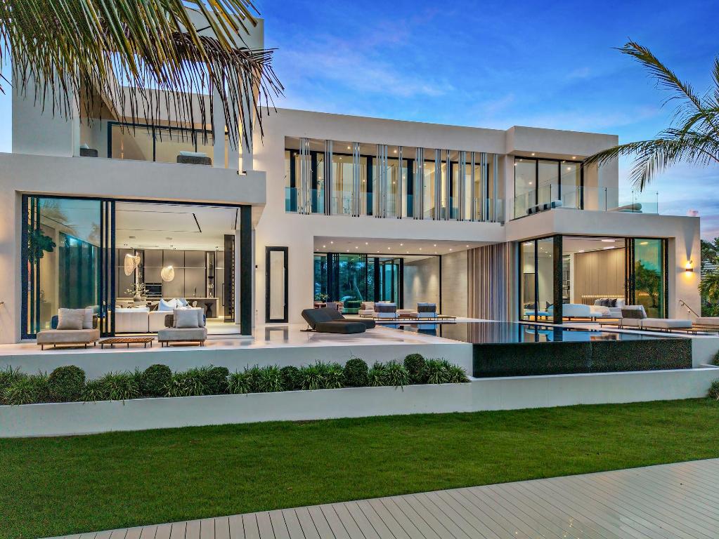 Showcasing refined modern architecture and rich natural materials, this exceptional six-bedroom custom residence by Ocean Blue Custom Homes reflects understated sophistication. Thoughtfully crafted with a minimalist sensibility, the home features gallery-like interiors and a seamless balance of warmth and contemporary design. Set within a tranquil natural enclave along a protected basin of the Intracoastal Waterway in coveted Point Manalapan, the property offers direct waterfront access complete with a private dock. The setting is both serene and exclusive, creating an ideal backdrop for elevated waterfront living. Enjoy access to the amenities of the Eau Palm Beach Resort & Spa, including private beach access, oceanfront pools, spa and fitness facilities, dining and resort services.