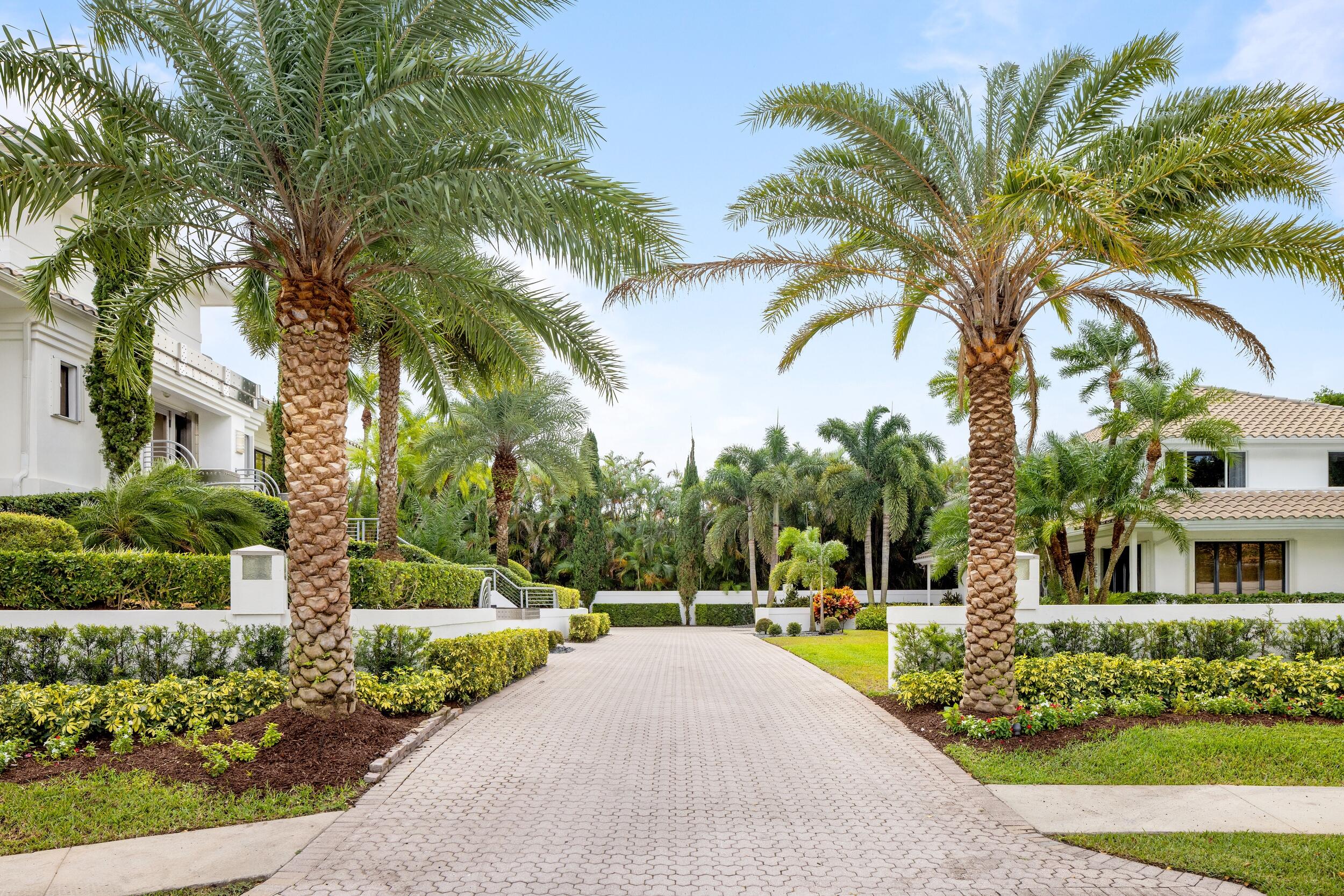 Situated on a coveted 0.81-acre double lot within the prestigious Boca Grove Country Club, this magnificent estate represents a private compound of unparalleled elegance. Comprising four individual structures, all seamlessly united under one single club membership, the property boasts a distinctive mid-century Italian modern motif that captivates upon arrival.
Upon entering the copper and stainless steel ornamented main residence (7,641sf) located on the second floor, a grand spiral staircase elegantly connects all three levels of this thoughtfully designed construction. Designed for both extravagant entertaining and privacy, the property features an owner's primary suite on the entire third floor.  SEE MORE.. Situated on a coveted 0.81-acre double lot within the prestigious Boca Grove Country Club, this magnificent estate represents a private compound of unparalleled elegance. Comprising four individual structures, all seamlessly united under one single club membership, the property boasts a distinctive mid-century Italian modern motif that captivates upon arrival.
Upon entering the copper and stainless steel ornamented main residence (7,641sf) located on the second floor, a grand spiral staircase elegantly connects all three levels of this thoughtfully designed construction. Designed for both extravagant entertaining and privacy, the property features an owner's primary suite on the entire third floor. This suite includes a lavish master bathroom with a glass-encased shower, separate closets for him and her, and an exterior cantilevered logia providing breathtaking views of the meticulously manicured golf course fairway.
The second floor hosts a modern European-styled eat-in kitchen, a grand formal dining room, a half bath, a relaxed family room, and a spectacularly appointed great room with a bar. The first "ground" floor accommodates two beautifully configured ensuite guest bedrooms, a gym, and a laundry-utility area with access to an attached oversized three-car finished garage, powered by a dedicated generator - first floor only.
On the southwest side of the property stands a separate and private structure (2,281sf), featuring a handsomely spacious man-cave-library with a half bath on the first floor, including hidden storage rooms and an attached oversized two-car finished garage. The entire second floor is designed as a self-contained, well-appointed guest suite with a full kitchen, sitting area, three bedrooms, two full baths, and a convenient utility-laundry space.
On the east side of the estate, a modernly devised resort-style pool, summer kitchen, separate spa, and an overall outdoor oasis were added in 2015, designed by the renowned South Florida architect Curtis Woodhouse. This luxurious and spacious area encompasses a free-standing contemporary glass-enclosed air-conditioned pool house (548sf) directly overlooking the pool, as well as a stand-alone cabana house (420sf) with one bedroom and a full bathroom, surrounded by lush tropical gardens. This property is the epitome of opulence and sophistication, offering a lifestyle of unparalleled luxury within a private and serene setting.