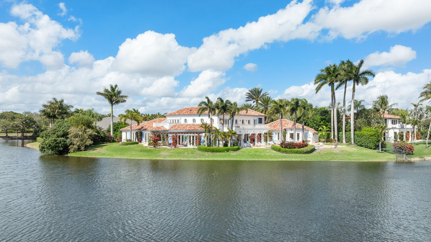 Located within the exclusive enclave of Fairway Island inside the prestigious Palm Beach Polo & Country Club, this estate is situated on over half an acre lot with breathtaking water views. This impressive waterfront property features 6 bedrooms and 6.5 bathrooms, including a private in-law suite ideal for extended family or guests. Designed with comfort and entertaining in mind, the expansive floor plan includes generous living areas, high ceilings, and large windows that fill the home with natural light while showcasing the surrounding water. Outdoor living is just as inviting, with a large heated pool, an extended patio perfect for gatherings, and serene waterfront scenery that provides stunning sunsets.