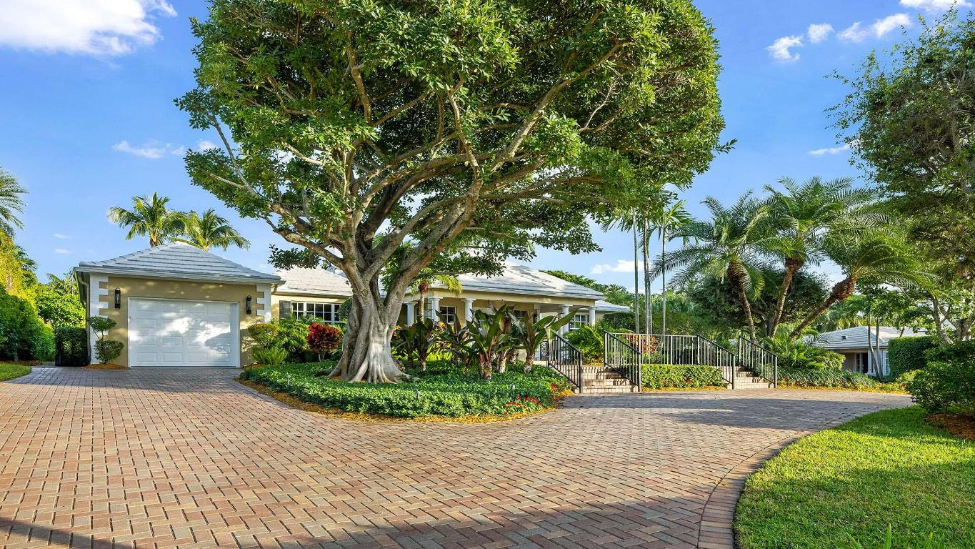 Elegantly positioned on the large corner lot of Polo Dr and Middle Rd, this Bermuda style residence sits in the heart of Gulf Stream. The property boasts an incredible elevation on one of the most desirable streets in town, and the location is truly a 10 out of 10. This is a rare and unique opportunity to own in one of the best neighborhoods in South Florida. This is priced at land value but offers a move in ready 4 bedroom, 4 bathroom home with a large outdoor space and pool. The home has been very well maintained and is in great condition. While a buyer may choose to update the residence, it is fully move in ready and filled with natural light throughout. The property features impact windows, beautiful tropical landscaping, covered outdoor space, and an inviting floor plan that blends comfort with classic style.

Inside, the formal dining room opens to the main living room with a fireplace, and the Florida room offers tranquil views of the pool and gardens. The large open kitchen includes a full service bar with a small refrigerator, ice maker, wine rack, and sink, making it ideal for entertaining.

The residence offers four bedrooms, all on a single level. The primary suite features a spacious closet, tub and shower, and direct access to the exterior overlooking the tropical pool setting. It serves as a private and peaceful retreat within the home.

Two additional bedrooms sit on the north side of the property and share a full bath with a generous central closet that creates a jack and jill style arrangement. The fourth bedroom provides flexibility for guests, an office, or additional living space.

Outdoor living is highlighted by a covered awning off the Florida room, which overlooks the pool and lush gardens. The property feels private, tropical, and inviting year round.

Additional features include a dedicated laundry room and a one car garage.

This property gives a buyer multiple paths: move in and enjoy the current home, renovate to perfection, or build a brand new residence on a spectacular corner lot in the core of Gulf Stream.