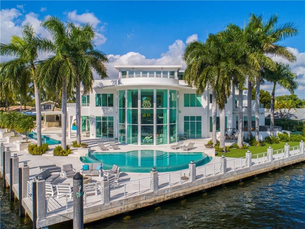 One of a kind, 3 level contemporary modern estate, renewed - masterpiece from its inception, where location meets luxury lifestyle, abundance, class, showcasing spectacular SE views of intercoastal w/unparalleled sunlight flow, inspiring “4ever young” feelings at best! Estate offers 5 bed (3 w/balconies), 7 full baths, 2 1/2 baths, office w/balcony, huge rooftop bar w/2800 sf of balcony and putting green/workout room, elevator, 3 Car Garage (w/lift 4CG), 267 feet of waterfront/concrete dock (125 intra/142 canal 9-10 feet deep), No Wake, water purification system, 72 kw Gen, 3 phase 600 amp service, dock 3 phase 2-200 amp pedestal and 1-50 amp pedestal, two pools, summer kitchen. Did I say “renewed” ($4MM+) New AC, electric, lighting, plumbing, quasi everything but block, windows and doors!