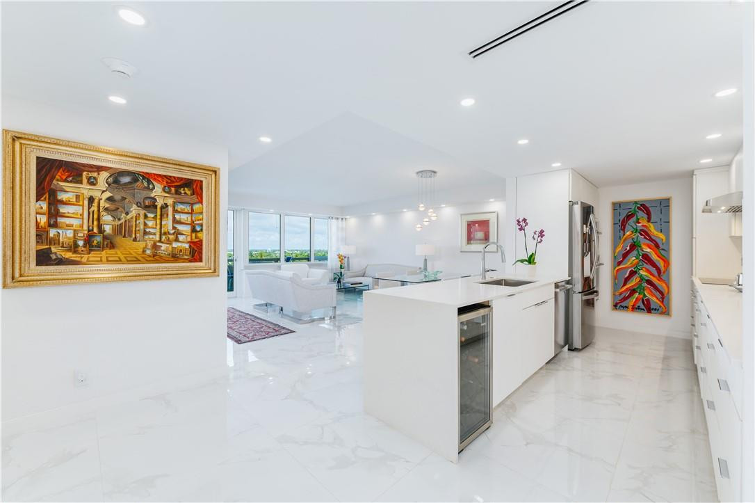 IMPECCABLY RENOVATED throughout, this designer unit offers MILLION DOLLAR VIEWS of the Intracoastal and Downtown Fort Lauderdale.  The state of the art kitchen includes a quartz waterfall counter island, Bosch and KitchenAid stainless steel appliances, custom designed cabinetry, an under the counter wine cooler, and plenty of counter space.  The flooring is polished porcelain throughout the unit, both baths are contemporary designed with large stall showers with rain shower heads and custom vanities, custom closet and bedroom doors throughout, guest bedroom designed as a combination den and bedroom, with a double murphy bed and large screen TV, hurricane windows and doors providing an unobstructed south view of the intracoastal from all the rooms. No Pets or Rentals Allowed - 55+ community
