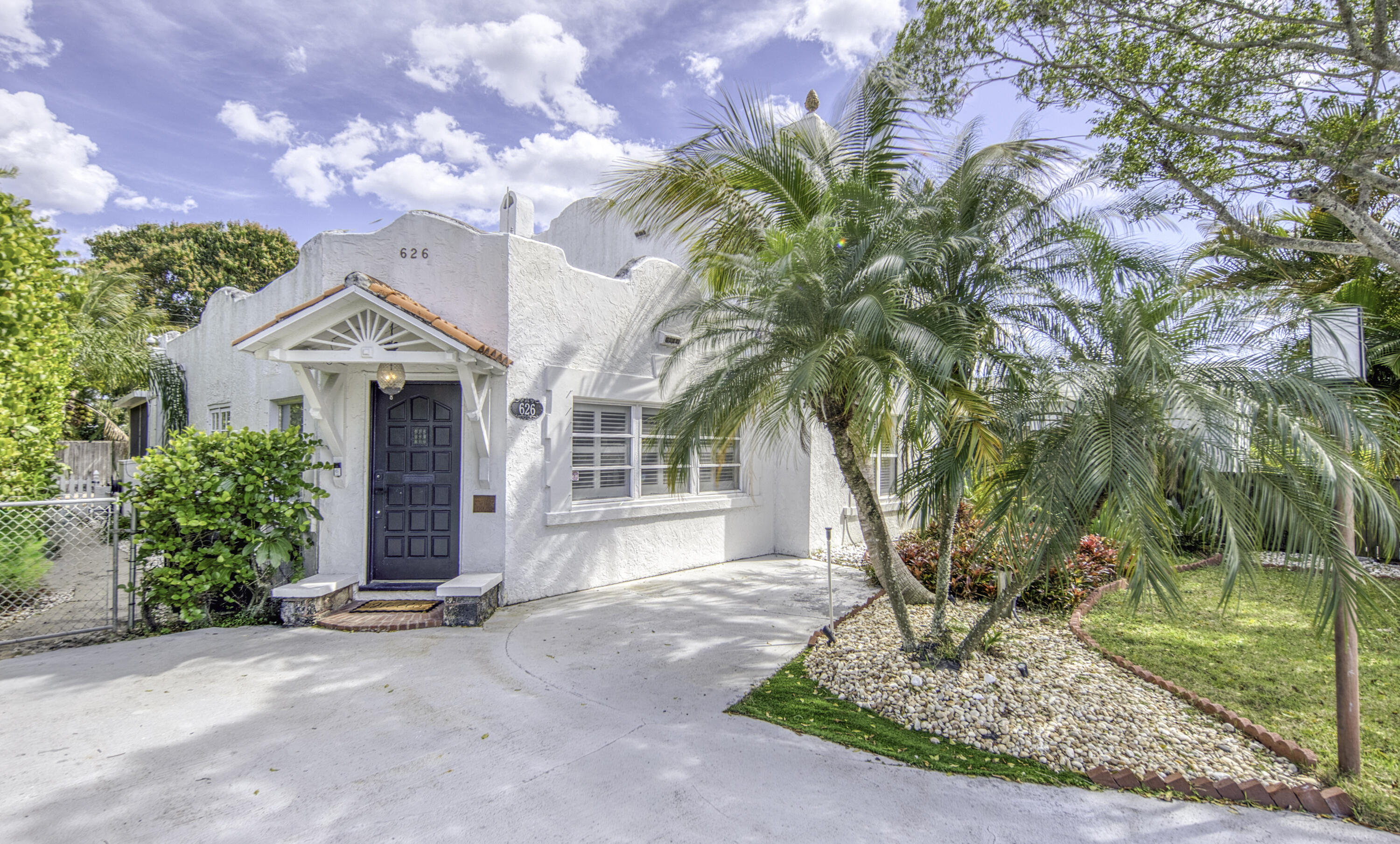 Stunning Spanish Mediterranean Luxury Home with waterfall Pool. Welcome to your dream oasis! A 5-minute drive to the beach, and less than 1-mile scenic walk or drive to beautiful views from the intercoastal bridge and downtown area with restaurants and shops. This exquisite 4-bedroom, 2-bath custom home is a true gem, offering a perfect blend of luxury and comfort. Nestled in the Mango Groves Neighborhood, this property boasts a gated driveway that ensures privacy and security.  As you step inside, you're greeted by a foyer with unique tiles and hardwood floors original to the home, leading to an expansive open-concept living area, filled with natural light.  The gourmet kitchen was recently renovated, featuring top-of-the-line appliances, custom cabinetry, and a spacious waterfall... ...and a spacious waterfall peninsula perfect for entertaining. This serene retreat is complete with two spa-like bathrooms, showcasing a soaking tub and walk-in shower. Four spacious bedrooms with large closets provide ample room for family and guests.  Step outside to your private paradise, where a beautifully landscaped backyard features a sparkling pool, perfect for relaxation and summer gatherings. This home is a rare find in this historic south Florida beach town, combining Mediterranean charm with modern luxury. Don't miss the chance to make this spectacular property your own!