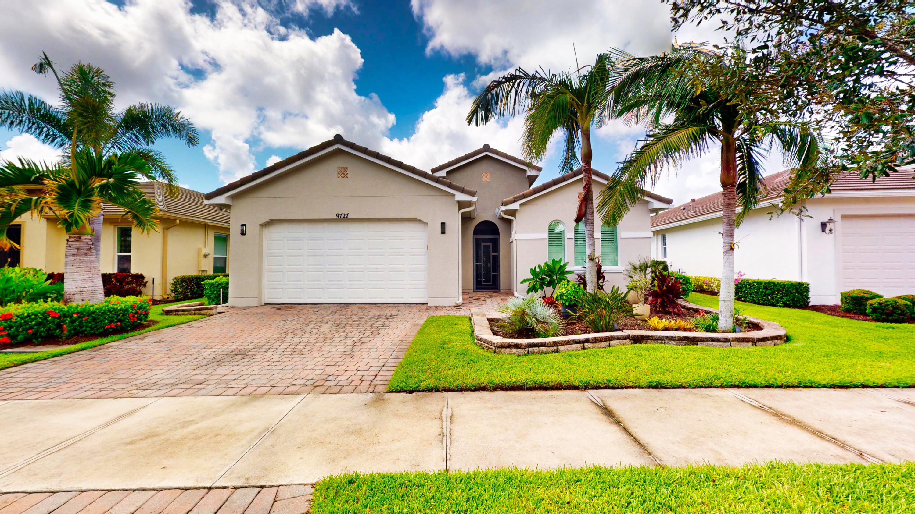 $40,000 PRICE REDUCTION!!! This beautifully appointed 2-bedroom, 2-bath home with a den offers over 2100 sq. ft. of luxurious living space and impeccable design throughout. The open floor plan features a spacious great room that flows seamlessly into the dining area and gourmet kitchen, complete with quartz countertops, 42-inch cabinets, and an upgraded gas range. Unique double glass French doors lead to an extended, covered lanai where you can enjoy stunning lake views and lush, upgraded landscaping, the perfect setting for entertaining or quiet relaxation. The home showcases elegant details such as crown molding, custom cabinetry, a barrel tile roof, and impact windows for peace of mind. The den includes built-in dual desks and cabinets, ideal for a home office or creative space. The oversized master suite overlooks the lake and features dual sinks, a walk-in shower, and a built-in vanity near dual closets. Guests will feel right at home in the secondary bedroom with its fully remodeled bathroom. A 4-foot garage extension adds valuable extra space for storage or hobbies. This home combines luxury, comfort, and functionality all set against a backdrop of breathtaking lake views.