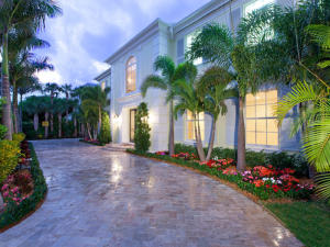 Experience the epitome of luxurious in-town living.  Located on the Ocean block of Peruvian Avenue, this home, originally built in 1997, was totally renovated and reconfigured in 2011. A soaring two story entry welcomes you to marble covered floors that glisten from the natural light beaming through impact windows and French doors.  A large gourmet kitchen, loaded with every amenity available, awaits a large gathering of family and friends. The wrought iron spiral staircase winds its way from the foyer to the second floor where you will find a massive master suite complete with his and her closets and a fabulous master bath, a library with custom built bookcases and a wet bar, 2 additional bedrooms with en suite baths, and a large open balcony overlooking the lushly landscaped grounds. loaded with every amenity available, awaits a large gathering of family and A downstairs guest suite keeps guests close to the action and has French doors opening to the beautiful and extremely private heated pool. Or if more privacy is desired, your guests can retire to a large 1 bedroom, 1 bath apartment with an office above the 4 car garage.  Enjoy all that this home has to offer and Palm Beach has to offer in this unique location just 1 block north of Worth Avenue.