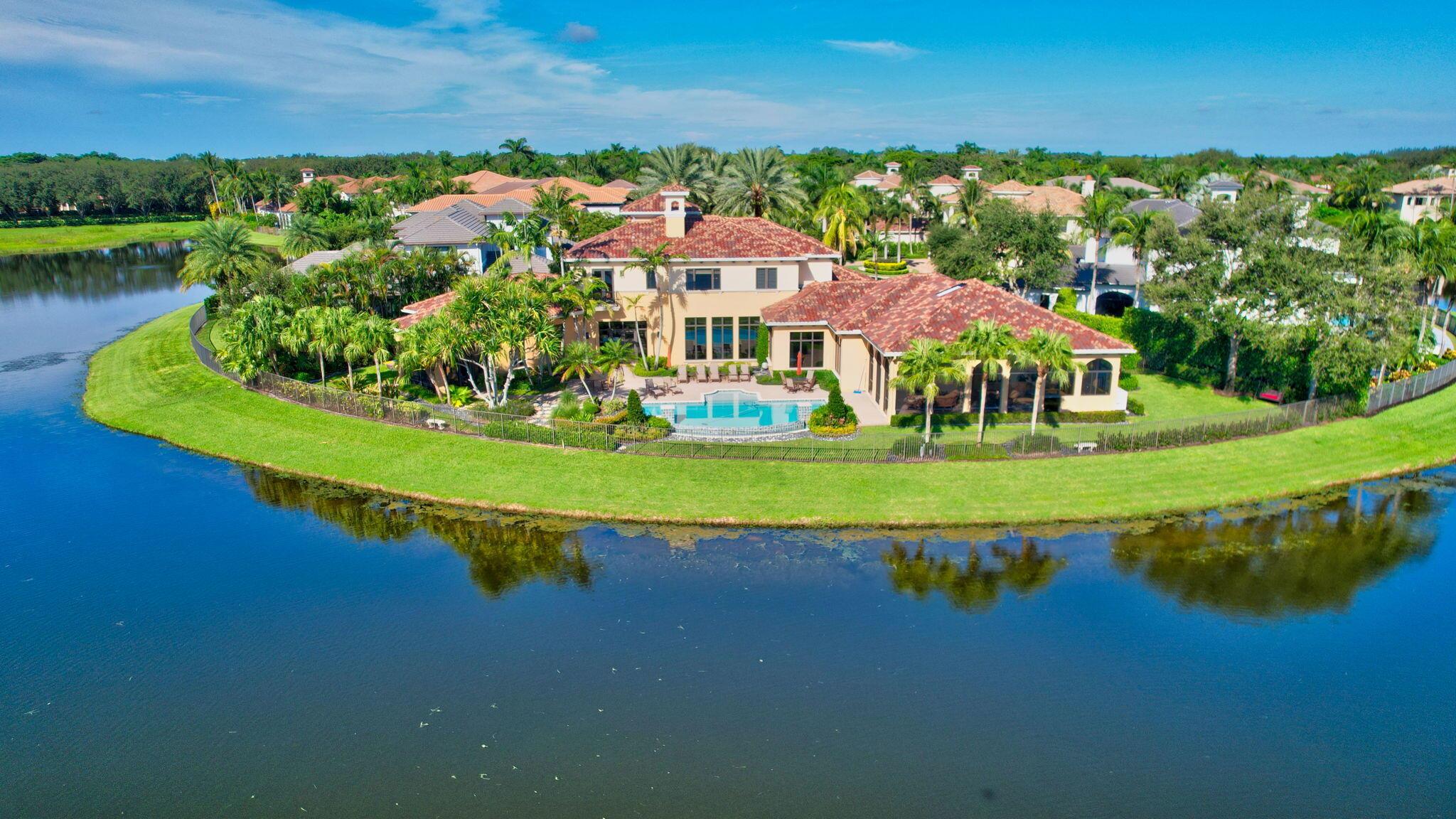 Located on one of the BEST LOTS in The Oaks! This 5-bedroom + office + den home is on a half-acre lot in a quiet cul-de-sac with sprawling lake views from 3 sides. The interior is open and bright, with volume ceilings and water views from every living space. The home features an elevator, smart home system, Sonos sound system, 2 laundry rooms, 4 outdoor cameras, 2 double garages, generator, and brand new roof & gutters. Gourmet kitchen with Wolf gas cooktop, double sinks, 2 Miele dishwashers, Sub-Zero fridge & refrigerator drawers. Ground-level master suite has a morning bar with Sub-Zero fridge, 2 W/Cs, and large custom closets. All guest bedrooms are ensuite. Outside, enjoy the beautiful lake views from a spacious patio area w/ resort-style pool, screened-in loggia, and summer kitchen. Furniture is negotiable.
