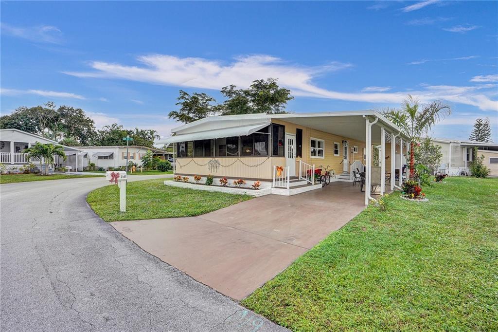JUST SIT IN YOUR ENCLOSED FLORIDA ROOM AND ENJOY THIS BEAUTIFUL FLORIDA WEATHER.  REALLY NICE AND VERY CLEAN LARGE CORNER MANUFACTURED HOME.  BEAUTIFULLY AND ALL FURNISHED TURN KEY.  TWO BEDROOM (+MURPHY BED IN LIVING ROOM) 2 FULL BATHROOMS. REMODELED BATHROOMS AND UPDATED KITCHEN.  TILE THROUGHOUT. NICE COMMUNITY FOR 55+ WITH LOTS OF ACTIVITIES.  SMALL PET OK. CLOSE TO RESTAURANTS, SHOPPING AND THE BEACH