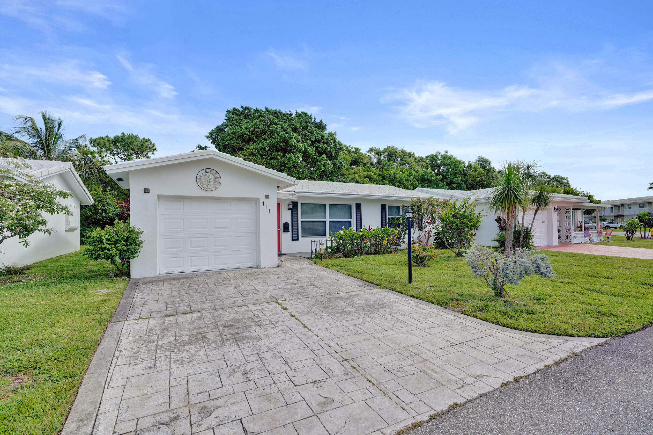 Welcome to this charming single-story residence in Leisureville Fourth Section, Pompano Beach. This two-bedroom, two-bathroom home offers total 1,347 square feet of comfortable living space, providing an efficient layout ideal for those seeking a manageable property to maintain. The home has impact glass in the majority of the home and hurricane rated doors, recent renovations including both bathrooms, AC and water heater, single car garage provides convenient vehicle storage and protection from the elements. Located in an established community, this residence presents an excellent opportunity for buyers looking to enjoy amenities and no hassle florida retirement living with access to all in this move-in-ready home with practical appeal and charm. No additional cost  9 hole par 3 golf.