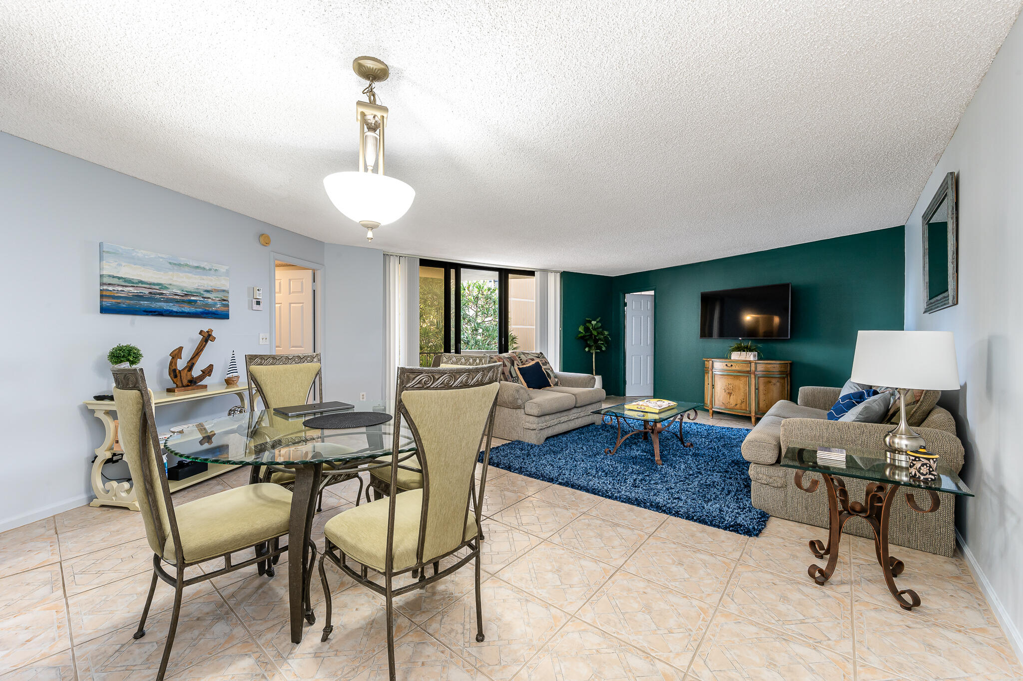 Experience oceanfront living at Phoenix Towers, 2800 N Ocean Drive, Apt. A-2B, Singer Island. This 2-bedroom, 2-bath residence offers 1,219 square feet of well-planned living space in one of Palm Beach County's established beachfront communities.  The home features a functional split floor plan with defined living and dining areas, central air and central heating, and ceramic tile flooring. Sliding glass doors open to a private balcony with views over the pool area, extending the living space outdoors and capturing the coastal setting.  The kitchen and baths are designed for everyday use and ease of maintenance, while the bedroom layout provides separation and privacy for owners and guests.  The residence is suitable as a primary home, seasonal retreat, or investment property, subject to association rules and buyer approval.  Phoenix Towers offers direct private beach access and a range of on-site amenities, including a pool, spa/hot tub, common community areas, and laundry facilities. Assigned parking and an organized association support a convenient, low-maintenance lifestyle.  Located on Singer Island, the property is close to shopping, dining, entertainment, golf, and marinas, with easy access to the broader Palm Beach area. This listing combines a practical floor plan, established building services, and a true beachfront location on the Atlantic.