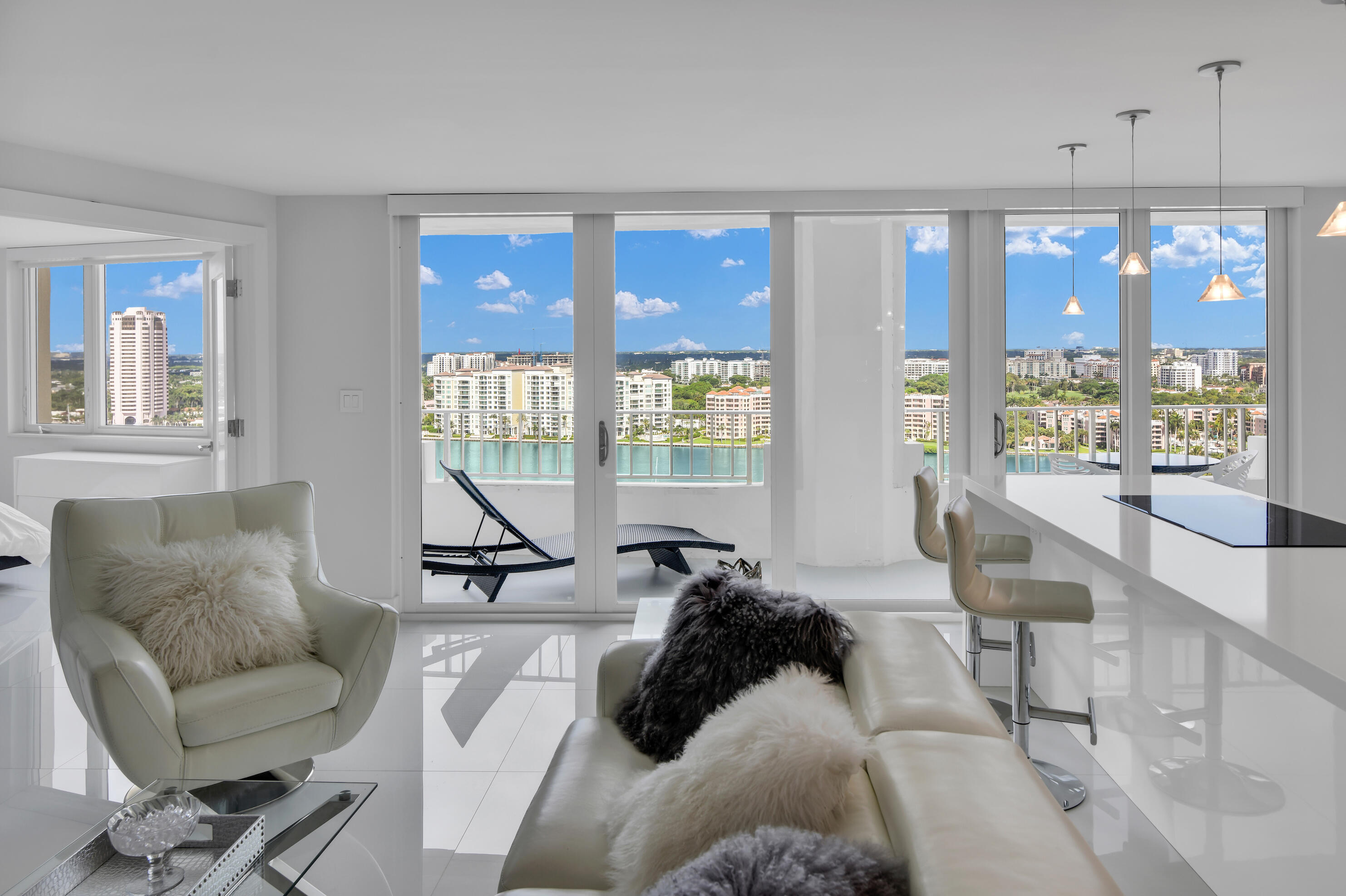 Perched on the 22nd floor, this stunning two-bedroom residence offers breathtaking, unobstructed views of the Intracoastal Waterway, spectacular sunsets, and sparkling city lights from every room. Completely remodeled with a modern open-concept design, this exceptional condo seamlessly blends luxury, style, and comfort. Located in a full-service beachfront building directly on the sand, residents enjoy private beach access and an exclusive coastal lifestyle. Resort-style amenities include an oceanfront swimming pool, state-of-the-art fitness center, and two tennis courts. Ideally situated in one of Boca Raton's most desirable beachfront locations, this residence is just minutes from the vibrant dining, shopping, and entertainment destinations of Mizner Park and Royal Palm Plaza.
