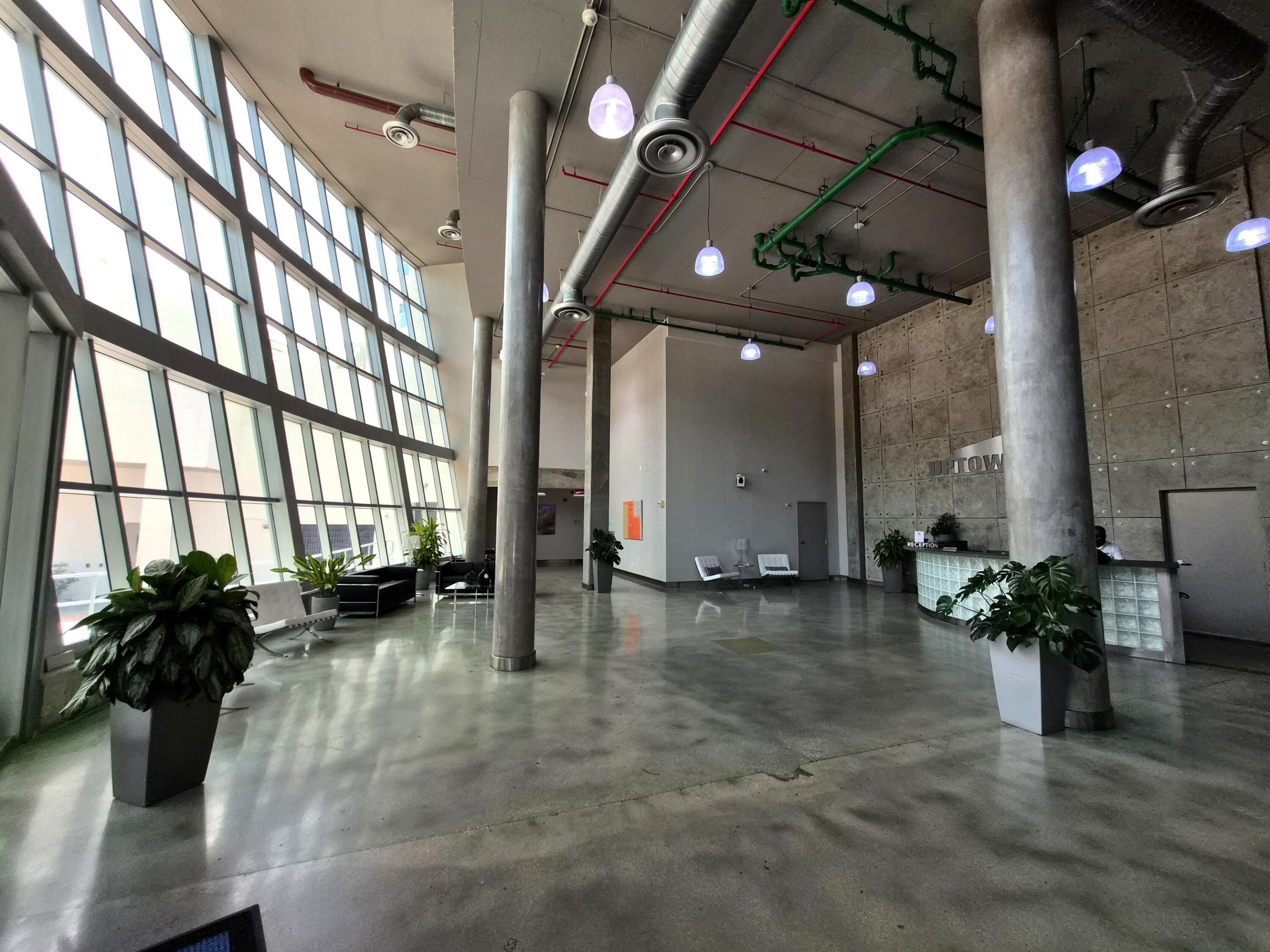Experience industrial-modern luxury at the highly coveted Uptown Marina Lofts in Aventura. This stunning 8th-floor 2BR/2BA residence features an airy loft layout with dramatic 11-foot concrete ceilings, architectural ductwork, and floor-to-ceiling impact windows. Unique to this unit are two private balconies offering dual-aspect views: unwind to tranquil Intracoastal waterway and marina views from one side, or overlook the tennis and basketball courts from the other. The sleek gourmet kitchen boasts premium granite countertops and stainless steel appliances, plus a convenient in-unit washer/dryer. Enjoy resort-style living with a waterfront infinity pool, fitness center & spa, private marina, and 24/7 valet/concierge!