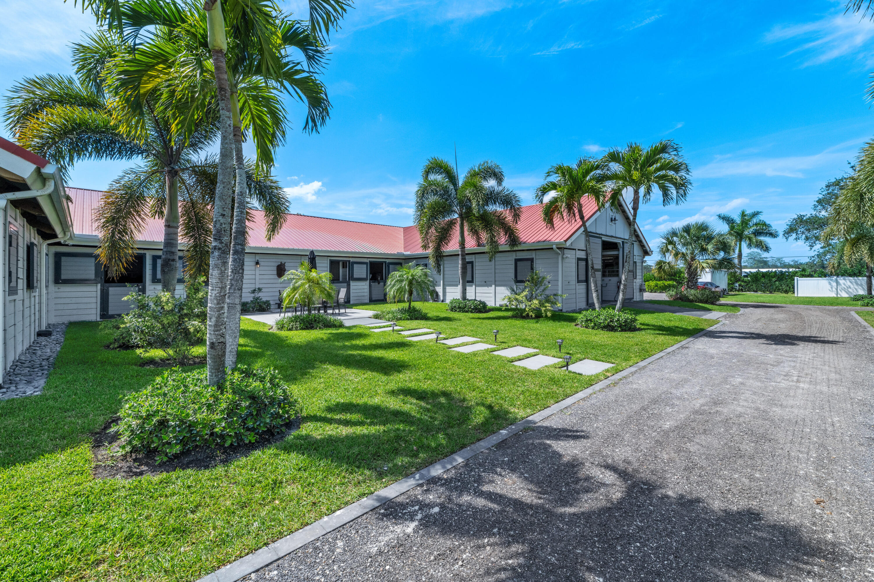 Just listed, a completely renovated, lushly landscaped, ready to go 5 acre farm well located in Wellington's South End. Serene and spacious 5 bedroom 4 bath main house perfect for family or guests. Includes 2 generators and oversized Aqua Soft Reverse Osmosis water system for house and barn. 15 stall main barn with 7 Oversized stalls featuring Amberway comfort mats, 3 stalls with walk out paddocks and 4 additional spacious paddocks. Equestrians will love the staff quarters freshly renovated with private kitchenettes for each of 2 bedrooms, along with tack room, feed room, 3 large grooming stalls and 4 wash stalls. A separate second barn boasts 3 oversized stalls, 2 with walkout paddocks. A newer Discount Dirtworks 120' x 245' fiber ring fenced with underground drainage. The ring is fenced with Amberway HDPE fencing. Just a short 8 minute drive to the new back entrance of Wellington International Showgrounds.