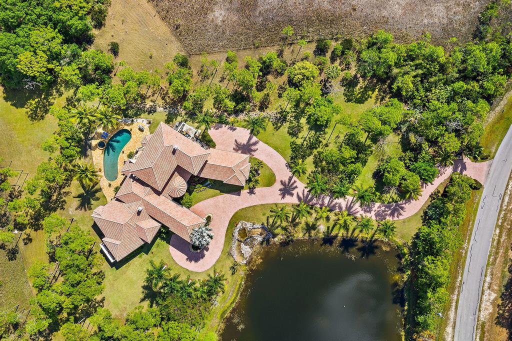 Peerless luxury home, which sits majestically on nearly 22 acres of private estate lot at the Ranch Colony. The property was designed with a pedigree of elegance offering 5 beds and 6.5 baths. The spacious master suite comes with a custom bathroom and an intimate outdoor bathing oasis. Fabulous for family living and entertainment, the 2-story house includes generous common rooms and an oversized kitchen. Details, including imported Mahogany doors, two custom fireplaces, a fitness room, a built-in library, and a monumental & illuminated staircase that leads to the media room. The architecturally detailed living room opens up to an incredible patio & the pool that blends naturally with the beautifully landscaped back yard. Ranch Colony is 1 of Florida's Most Elite Luxury living communities.