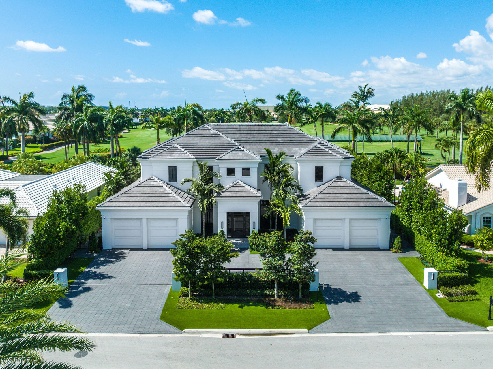 Premium location within Royal Palm Yacht & Country Club on the brand-new Jack Nicklaus Signature Golf Course. 170 Royal Palm Way is a turnkey SRD Building Corp. Signature Estate that offers a slice of paradise with 102' of golf course frontage. Contemporary chic style is found inside the 5 bedroom, 7,200+ living space with an open floor plan, towering windows, and trendy interiors. The home includes a formal dining area, club room with stunning bar, dedicated study, multiple living rooms, and a sprawling 1st-floor main suite complete with morning bar, glass shower room, and His & Her boutique closets. The backyard has southern exposure and is a tropical escape. The dazzling pool is the perfect centerpiece, wrapped by a large patio, covered loggia, summer kitchen, and infinite golf views.
