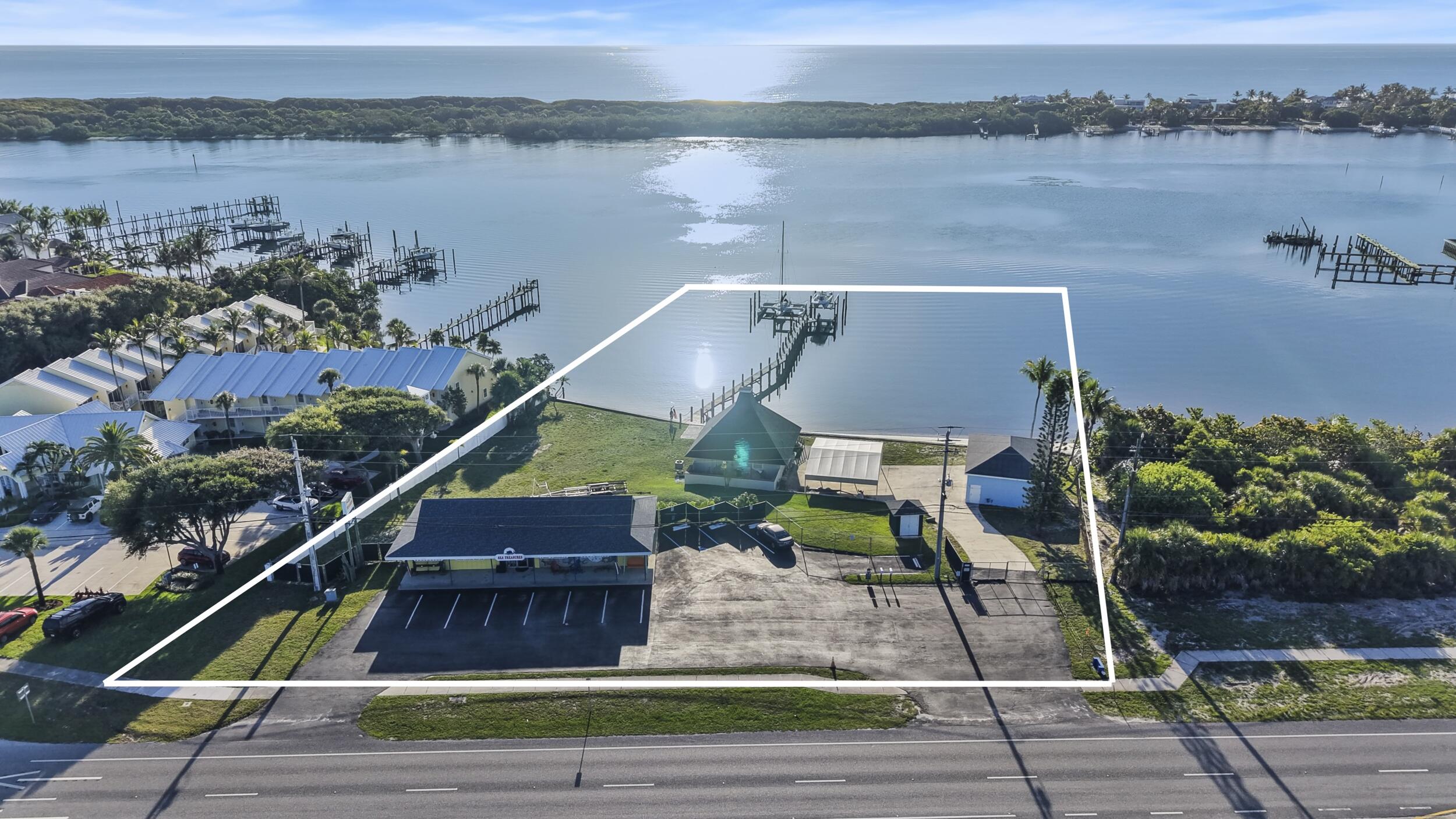 A truly rare waterfront redevelopment opportunity on prestigious US Highway 1 in Jupiter, offering approximately 220 feet of waterfront with a private beach, a 186-foot dock with two 50-foot boat slips, and 225 feet of prime US Highway 1 frontage. The property features a Commercial Waterfront Future Land Use designation and is strategically positioned between two existing Waterfront Resort Commercial (WRC) properties, presenting exceptional long-term redevelopment potential, subject to Martin County approvals. Located in Martin County, the property also offers the advantage of lower taxes while enjoying a premier Jupiter location. An extraordinary opportunity for investors, developers, or end users seeking one of the area's most unique waterfront properties. Currently zoned as R-3A with a retail store and residence.
