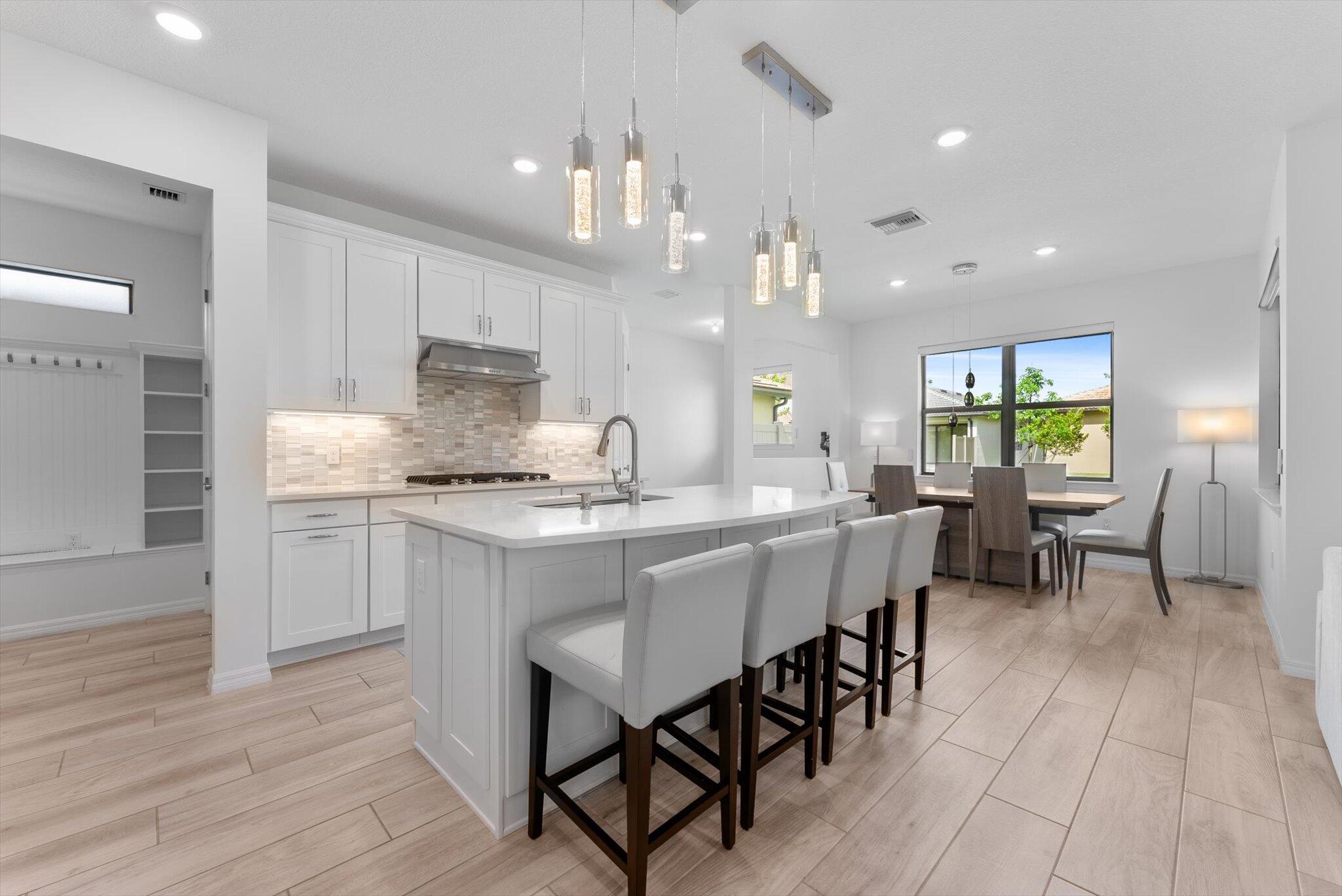 Built in 2023, this beautifully upgraded home offers all the benefits of newer construction, including impact windows, a newer roof, and modern systems for years of worry-free living. The open-concept floor plan features a fully upgraded kitchen with quartz countertops, premium cabinetry, stainless steel appliances, and elegant finishes throughout. Enjoy motorized blinds in every room, all controlled with Alexa for effortless smart-home living. Located in a secure, family-friendly community with two resort-style clubhouses offering pools, fitness centers, basketball and tennis courts, playgrounds, parks, and walking trails. HOA includes landscaping, making maintenance a breeze. Conveniently located near the Florida Turnpike with easy access to shopping, dining, and top-rated schools.