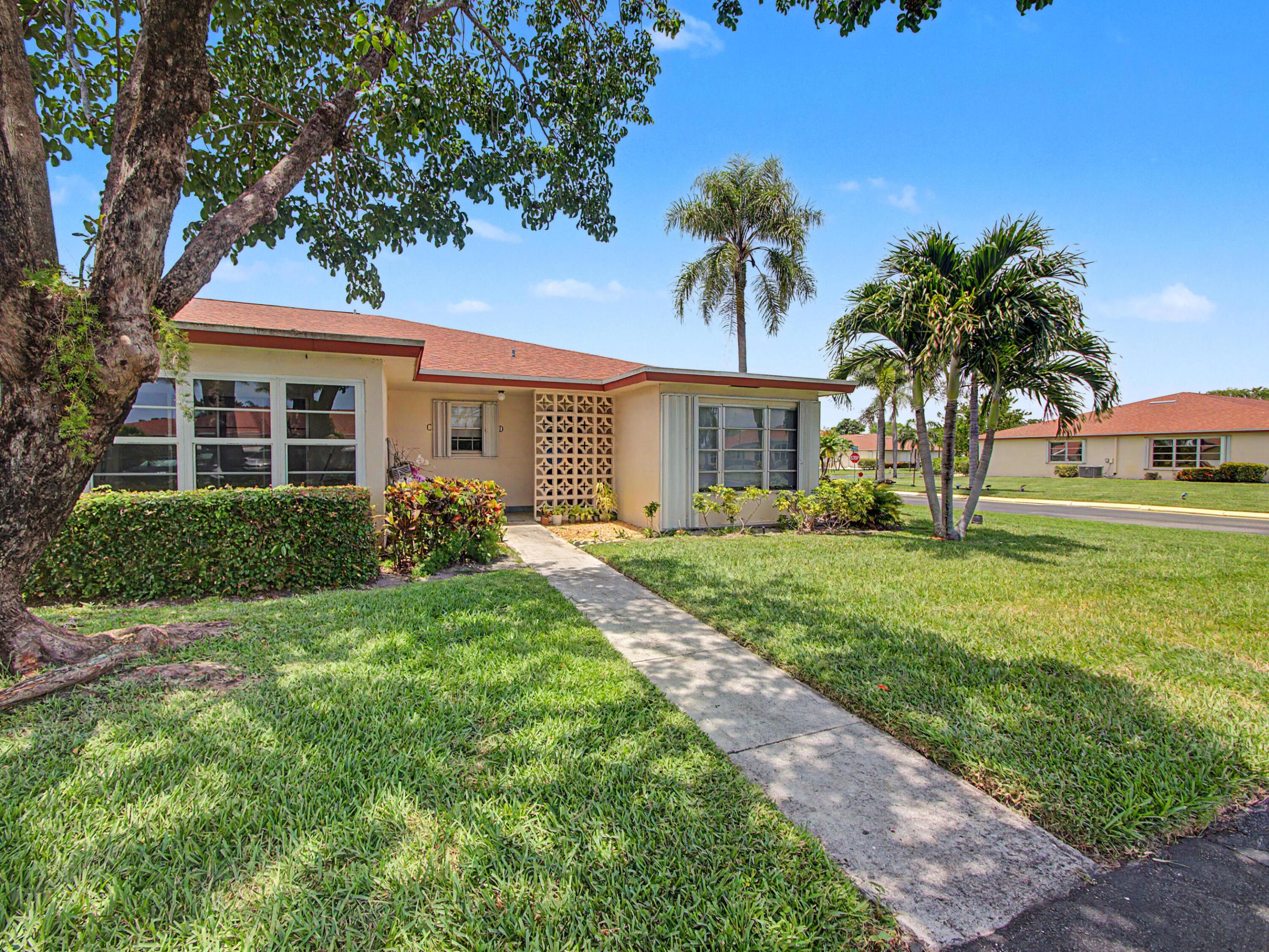 Step into this stunning, fully renovated 2BR/2BA corner villa, where abundant natural light and stylish modern finishes create the perfect blend of comfort and elegance. Featuring sleek 30x30 porcelain tile flooring throughout, this bright and airy home boasts an open-concept kitchen with granite countertops, decorative backsplash, upgraded cabinetry with convenient pull-out drawers, and stainless-steel appliances.  The spacious Florida room, enclosed under air with leveled flooring, provides the perfect space to relax, entertain, or enjoy year-round living. Both bathrooms have been beautifully updated with walk-in showers, designer vanities, and contemporary finishes. The generous bedrooms offer mirrored closet doors and custom California Closet systems for exceptional organization and  storage. Additional enhancements include recessed high-hat lighting, a 2021 A/C system, and tasteful furnishings throughout. Offered fully furnished and turnkey, this move-in-ready gem allows you to start enjoying the Florida lifestyle from day one. Located in an active and sought-after 55+ community, residents enjoy a newly renovated fitness center, resort-style heated pool, clubhouse, and an array of social activities and amenities designed for carefree living.