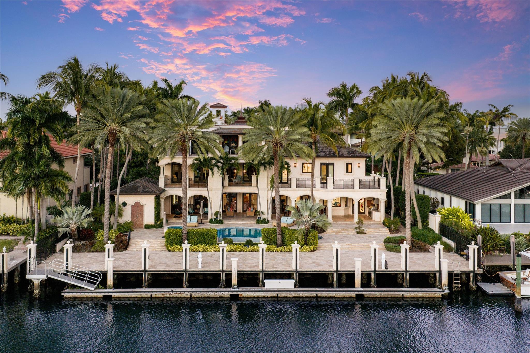 Located in the exclusive gated, security-patrolled community of Harbor Beach, this exceptional French Provincial waterfront estate showcases superior construction, exquisite finishes & a rare 18,000 SF lot. Offering 120' of deepwater frontage on a wide canal with turning basin, the property is just four homes from the Intracoastal with quick ocean access and sweeping water and skyline views. Features include marble/engineered wood flooring, custom moldings, elegant living spaces, an expansive primary suite w sitting area and private balcony, wraparound terraces, summer kitchen, freshwater pool, and Savant automation. April 2026 upgrades include a new roof with lifetime material warranty, exterior painting, pool resurfacing/retiling, upgraded driveway, and refinished door hardware and more