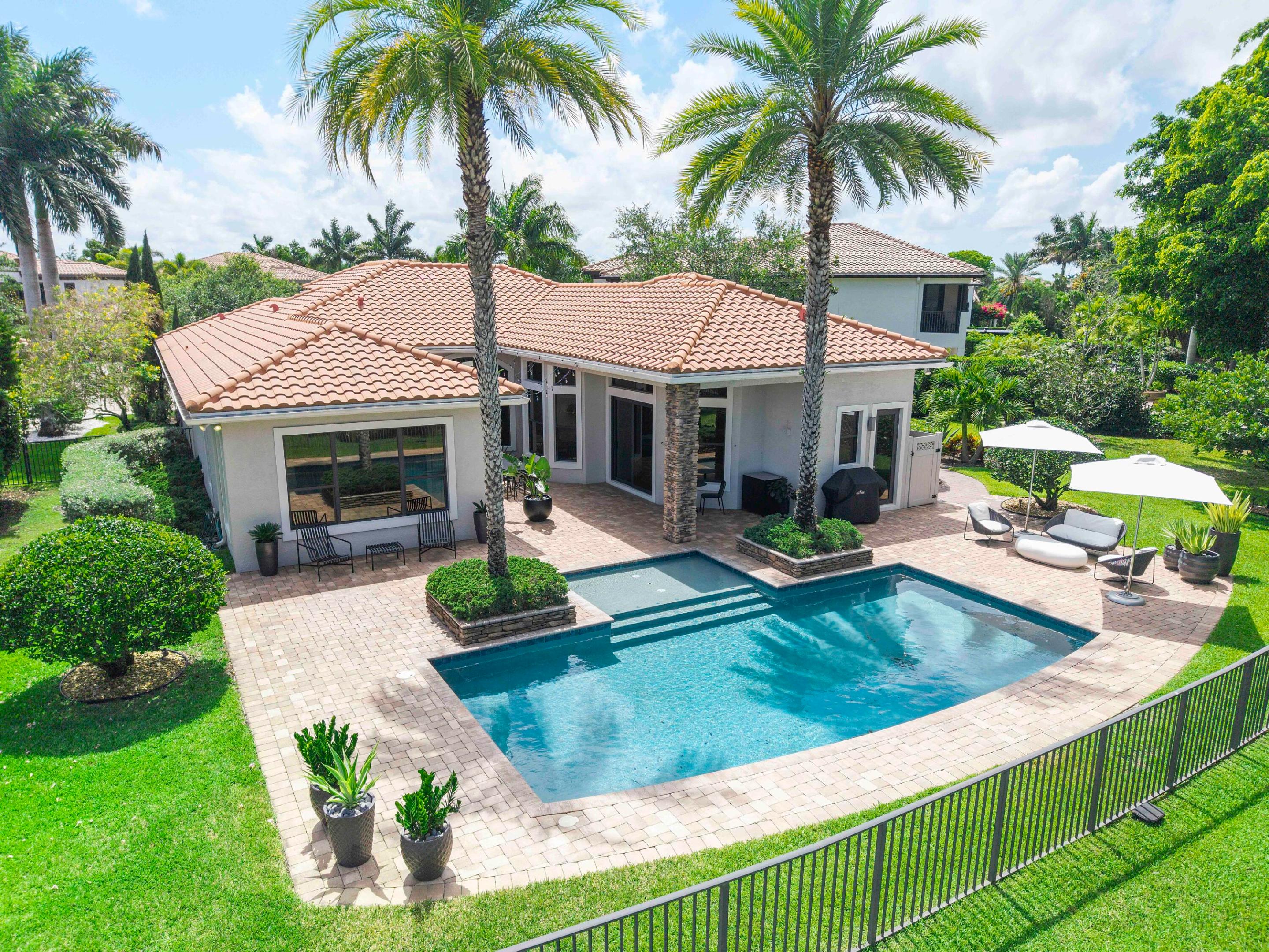 Beautifully updated one-story home in prestigious PGCC on oversized pie-shaped cul-de-sac lot with spectacular water & golf views overlooking the 13th fairway. This 4BD/3.5BA home features a triple-split floor plan, volume ceilings, formal living and dining rooms, hardwood flooring & oversized 32x32 porcelain tile. The expanded gourmet kitchen has been beautifully renovated with quartz countertops, updated cabinetry, floating shelves, designer hood, & brand-new high-end appliances including Sub-Zero refrigerator, Bosch double ovens & dishwasher, wine fridge & gas stove. Resort-style backyard with saltwater pool, sun shelf, outdoor shower, & AquaCal pool heater/chiller. Additional upgrades, renovated baths, updated lighting and & fixtures, newer AC's & hot water heater, full home generator.