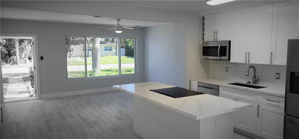Come see this Beautifully Remodeled 3 Bedroom 2 Bathroom Home in the Heart of Flamingo Village. The home has a new roof with warranty, Hurricane Impact Windows throughout. New updated kitchen with White River Granite and Bartop for Entertaining Guests. The home has New Vinyl Waterproof flooring throughout. New baseboards, New Lights, Fans Fixtures. Brand new stainless steel appliances w/ center Island Stove, 2 fully remodeled bathrooms. The home has been freshly painted inside/out and stucco textured. A nice privacy fence and a nice Carport area w/ extra parking in the driveway. Over 75,000 in remodels upgrades. Very close to 595/I-95, local supermarkets, 5 minutes from the Casino, and dock your Boat in Riverland with Ocean Access!  Don't Miss out on this Gem, it wont last!!!!