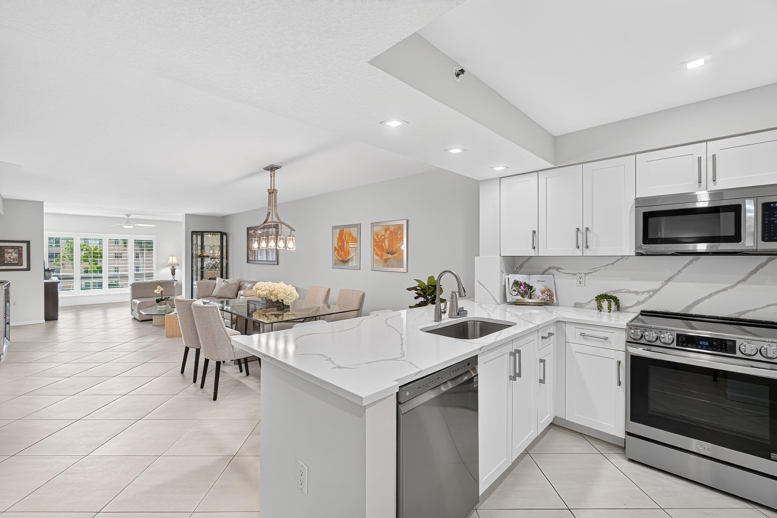 COME SEE THIS "PRISTINE & BRIGHT" 2 BEDROOM (plus den!) 2 BATH "CHARDONNAY" CONDO w/ SUNNY FLORIDA ROOM w/ SERENE LAKE VIEWS!  THE  FABULOUS BRAND NEW OPEN KITCHEN FEATURES QUARTZ COUNTERTOPS (room for 3 barstools) , CRISP WHITE CABINETS & TOP OF THE LINE S/S APPLIANCES!  THE LARGE PRIMARY BEDROOM HAS A HUGE CUSTOM FITTED WALK-IN CLOSET & STUNNING LAKE VIEWS!  THE DEN IS GREAT FOR AN OFFICE OR TV ROOM & FEATURES FABULOUS STORAGE CLOSETS w/ DRAWERS & CUSTOM SHELVING. RELAX IN THE FLORIDA ROOM w/ PLANTATION SHUTTERS & SHIMMERING LAKE VIEWS. MOVE-IN READY! CORAL LAKES HAS AN AWARD WINNING NEWLY REMODELED CLUBHOUSE w/ A 600 SEAT THEATER FOR MOVIES & ENTERTAINMENT, RESTAURANT, FITNESS CENTER, ART STUDIO, MANY RESORT POOLS, TENNIS & PICKLEBALL, OVER 40 CLUBS TO JOIN & CARD GAMES TO PLAY, ETC..