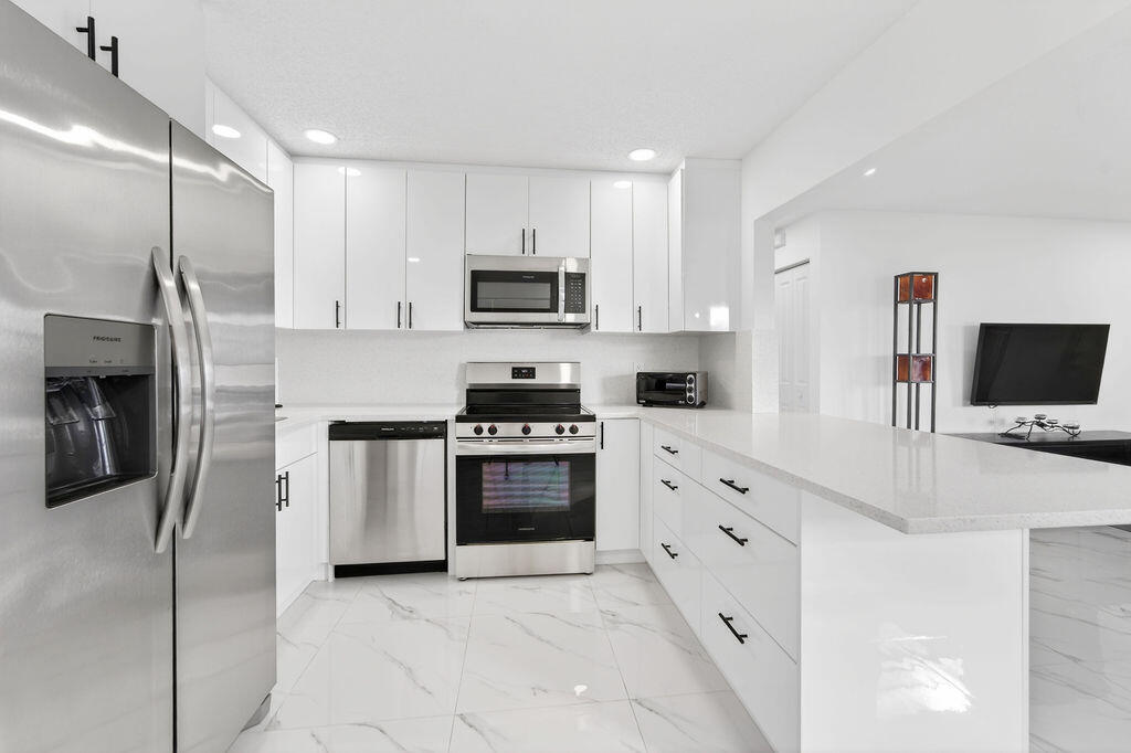 This 2 BR, 1 BA  home is completely remodeled in active 55+ community with low HOA fees. Porcelain tile throughout, new stainless-steel appliances, quartz countertops, new washer and dryer included, 2024 water heater, 2018 air conditioning unit, accordion shutters throughout, retractable awning, expanded driveway, paver patio. HOA community includes free golf, every 5 years pressure washed, every 5 years repainted, three heated pools, clubhouse, fitness center, library, game room, bocce, barbecue picnic area, social event clubs, and more!  This home combines comfort with convenience and is minutes from shopping, dining, recreation and medical facilities. HOA amenities and social lifestyle make this a great opportunity.