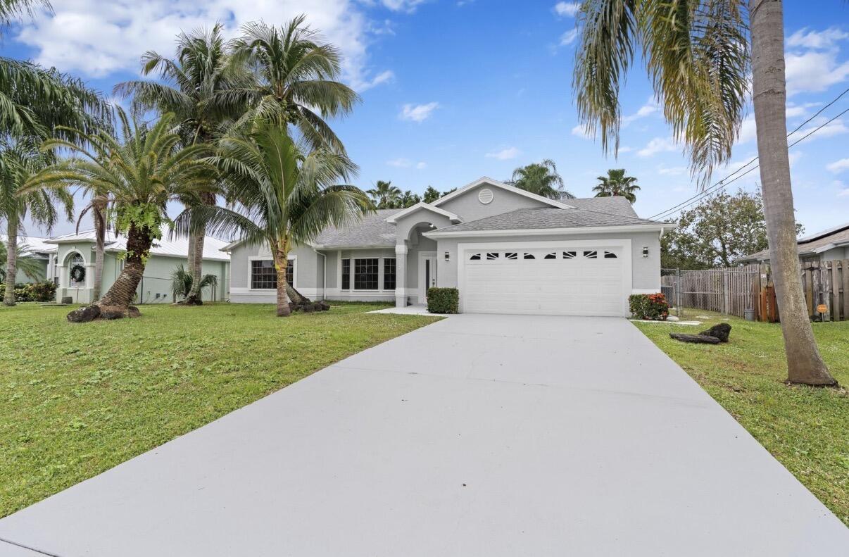 Welcome to this 3-bedroom, 2.5-bathroom single-story residence in Port St. Lucie Section 13, offering 2,038 square feet of finished living space. This waterfront property provides a serene setting while maintaining convenient access to the area. The home features a 2-car garage and thoughtfully designed floor plan across one level. Situated on waterfront acreage, this residence presents a distinctive opportunity for those seeking a waterfront lifestyle in Port St. Lucie.