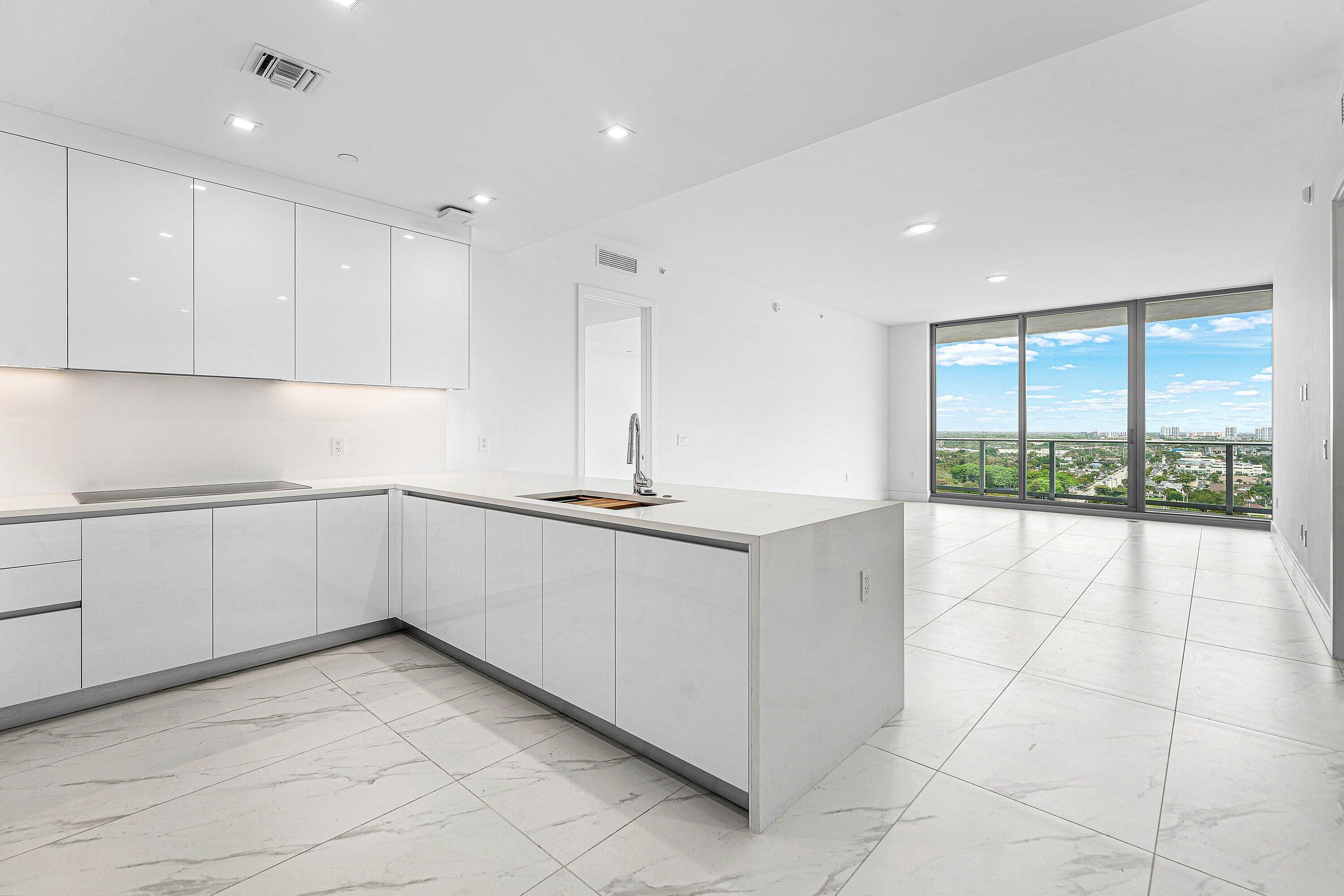 New construction without the new-construction premiums. A never-lived-in resale at Nautilus 220, Residence 1613 delivers the rare advantage of brand-new construction without the added developer capital contribution and closing costs. Set on the highly desirable A.07 floor plan in the preferred North Tower, this 16th-floor residence pairs easy access to the community's premier amenities with wide Intracoastal views, marina vistas, and the blue horizon of Singer Island. For buyers seeking value, elevation, convenience, and never-lived-in condition, this offering stands apart. Nautilus 220 offers a full-service waterfront lifestyle with a one-acre resort deck, pool, spa, fitness center, yoga and spin studios, sauna, steam rooms, club room, theater lounge, golf simulator, bowling lounge concierge, valet, guest suites, on-site dining, and private beach club access on Singer Island. In the heart of the Lake Park Waterfront District, this is a rare chance to own a newly completed luxury condominium that feels both elevated and immediate. Located in the evolving Lake Park Waterfront District, this residence offers a rare opportunity to enjoy a blend of new construction, elevated views, and effortless access to everything. Enjoy a lifestyle defined by ease, design, and proximity to the water.