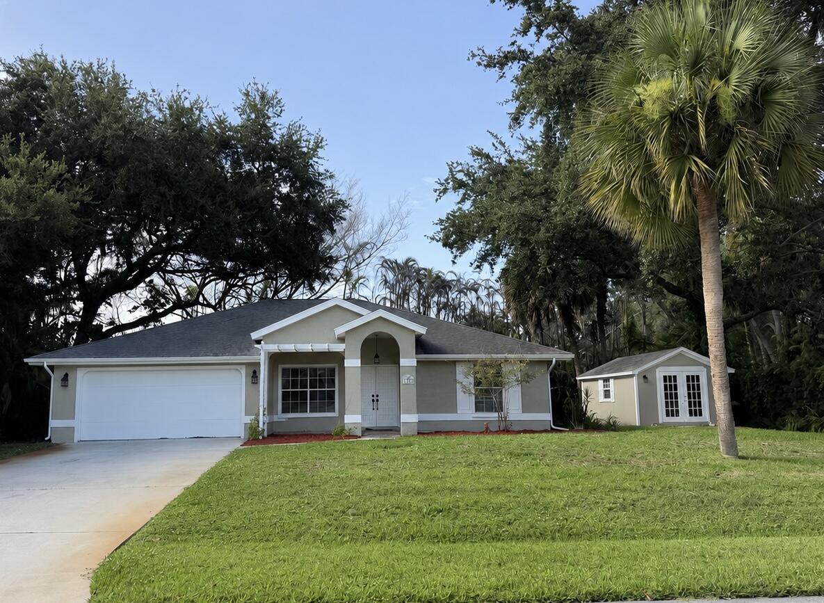 Nestled among lush tropical landscaping and majestic oak trees, this 3 bedroom, 2 bath home offers 1,622 sq ft of living space. Built in 1992 this home is being offered furnished, making ideal as a primary residence, seasonal retreat or investment property. Inside the home featured vaulted ceilings, skylight, terra-cotta flooring thought out.  The kitchen has white cabinets and granite countertops, a pantry and washer and dryer for added convenience. The primary suite features a walk-in closet and en-suite bath, while two additional bedrooms provide plenty of space for family, guests, or a home office. Exterior has been freshly painted there is a shed, currently being used as an art room, with water hook up, flooring needs repair. Conveniently located near Downtown, Beach, and Shopping
