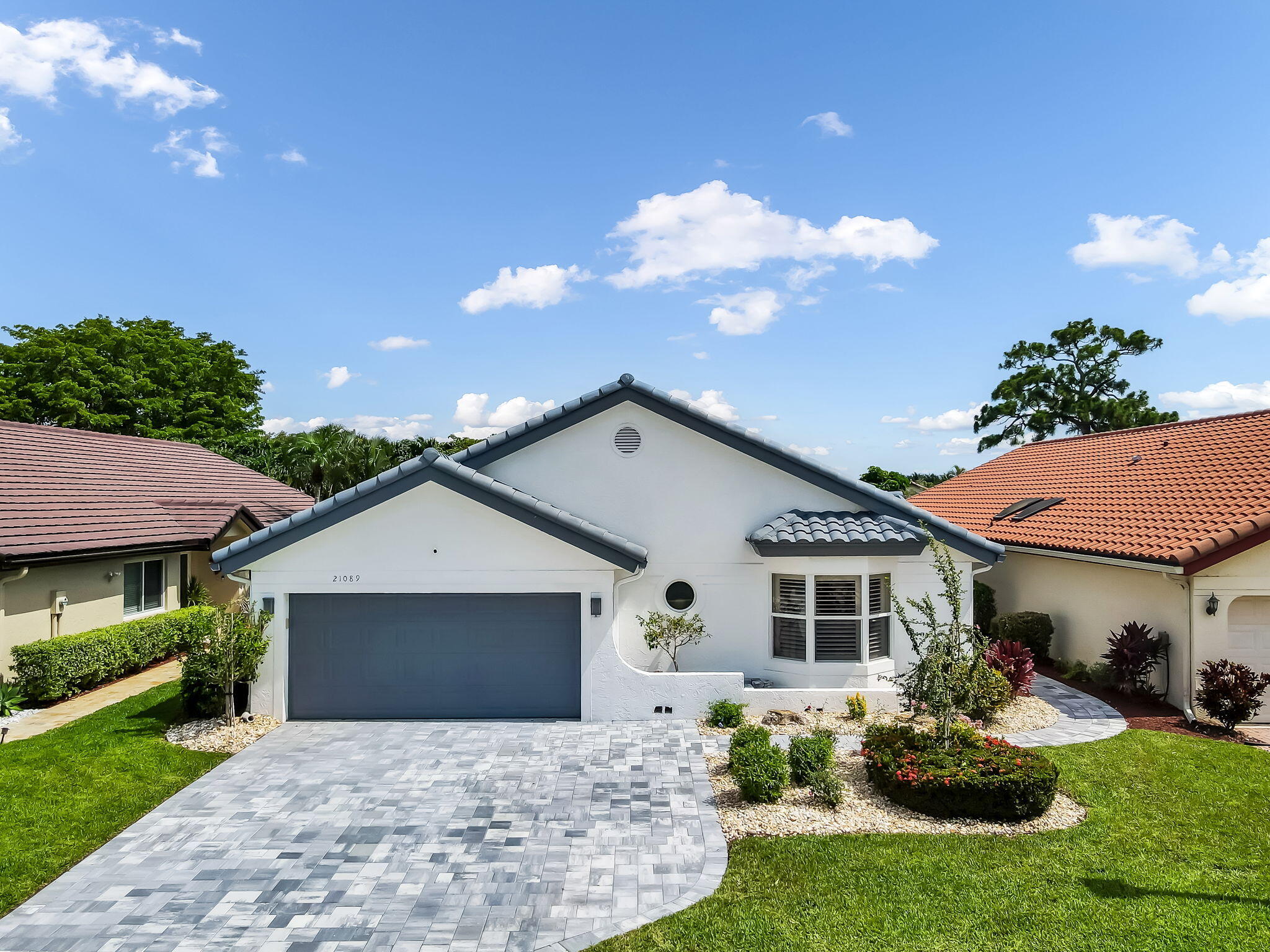 Welcome to Boca Woods Country Club. Exceptional updated home with impact windows & doors features two bedrooms, two baths plus an office/den w/direct access to a patio. Bright open-concept floor plan offers seamless flow between the living, dining & kitchen areas creating an inviting space for everyday living and entertaining. Additional features include granite counter tops, SS appliances & wet bar. Step outside to a screened in patio with a sparkling pool overlooking a tranquil lake view. Boca Woods CC offers two 18 hole championship golf courses, tennis, pickleball, fitness center, spa and dining. Great opportunity to  live in one of Boca Raton's most sought-after country club communities. Mandatory Membership $150,000 paid 10 days prior to closing. See Attachments for additional fees.