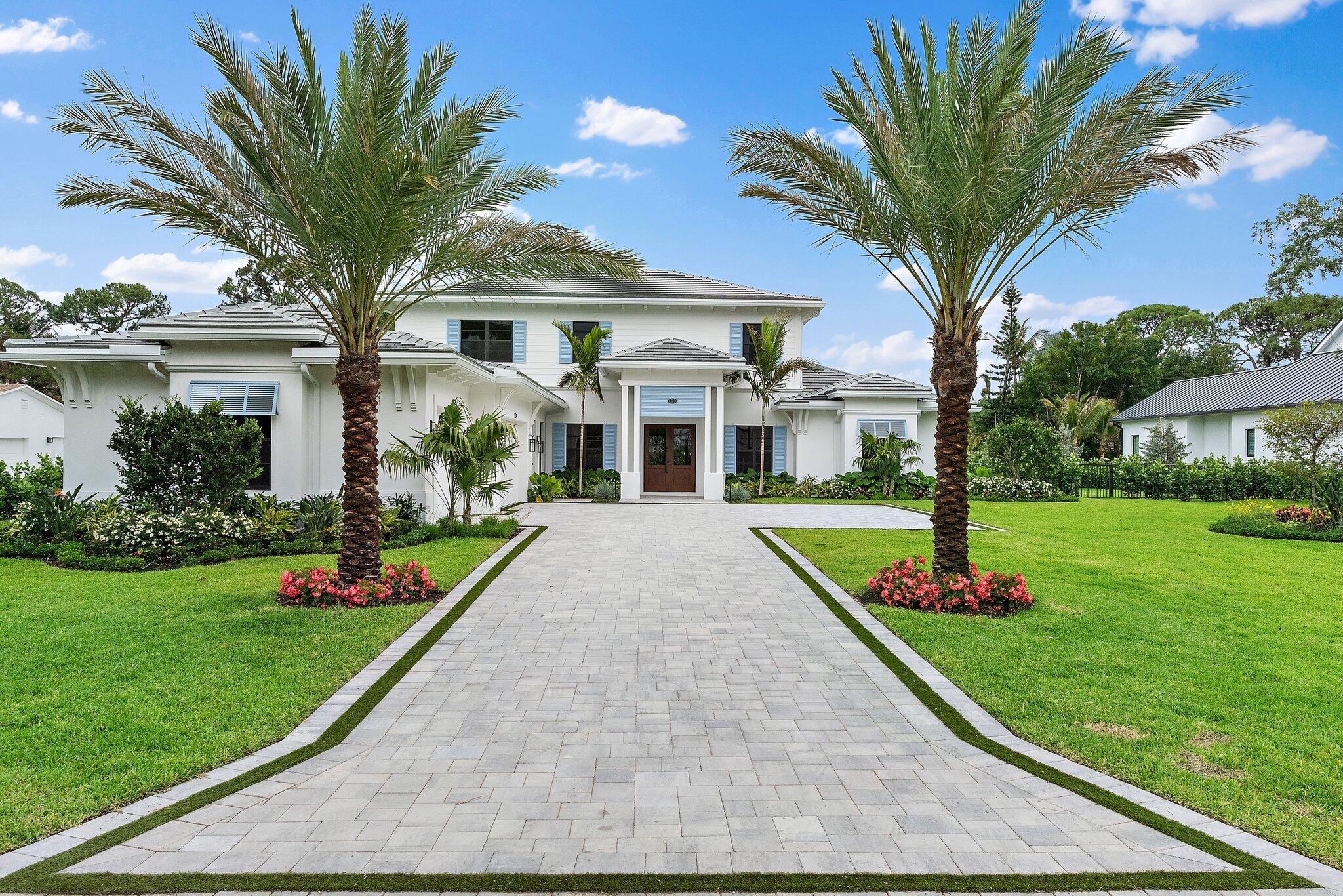 This is a rare opportunity to own new construction in one of Jupiter's most prestigious and established neighborhoods, Pennock Point. Large homesites, a tucked-away feel, and close proximity to the water define the lifestyle.  Thoughtfully designed with both everyday living and entertaining in mind, the home features soaring ceilings and a seamless, light-filled floor plan. The chef's kitchen is a true centerpiece, complete with premium appliances, gas cooktop, butler's pantry, and an effortless flow into the main living spaces. Wide-plank wood flooring and custom lighting add warmth in every space.    The first-floor primary suite is a private retreat. The primary bath offers marble flooring, large closets, vanity space, a free-standing tub and coastal accents.  The large bedroom overlooks the resort-style pool and lush landscaping. Also on the main level, you'll find a dedicated office, a spacious laundry room, and a three-car garage for added convenience.  Upstairs, three beautifully appointed en-suite bedrooms are complemented by a versatile loft space. Designed as a perfect playroom, media room, or additional lounge area.     Bonus interior features include custom trim work and doors, oversized laundry room with double washer/dryers, wiring for sound and security, epoxy garage floor, and spray foam insulation. Exterior value-add items include ½ acre fully fenced lot, summer kitchen, 500-gallon buried propane tank, automated pool equipment, and porcelain pool patio. This home captures the essence of Palm Beach-inspired design with its crisp blue shutters, expansive windows, and coastal modern architecture.
