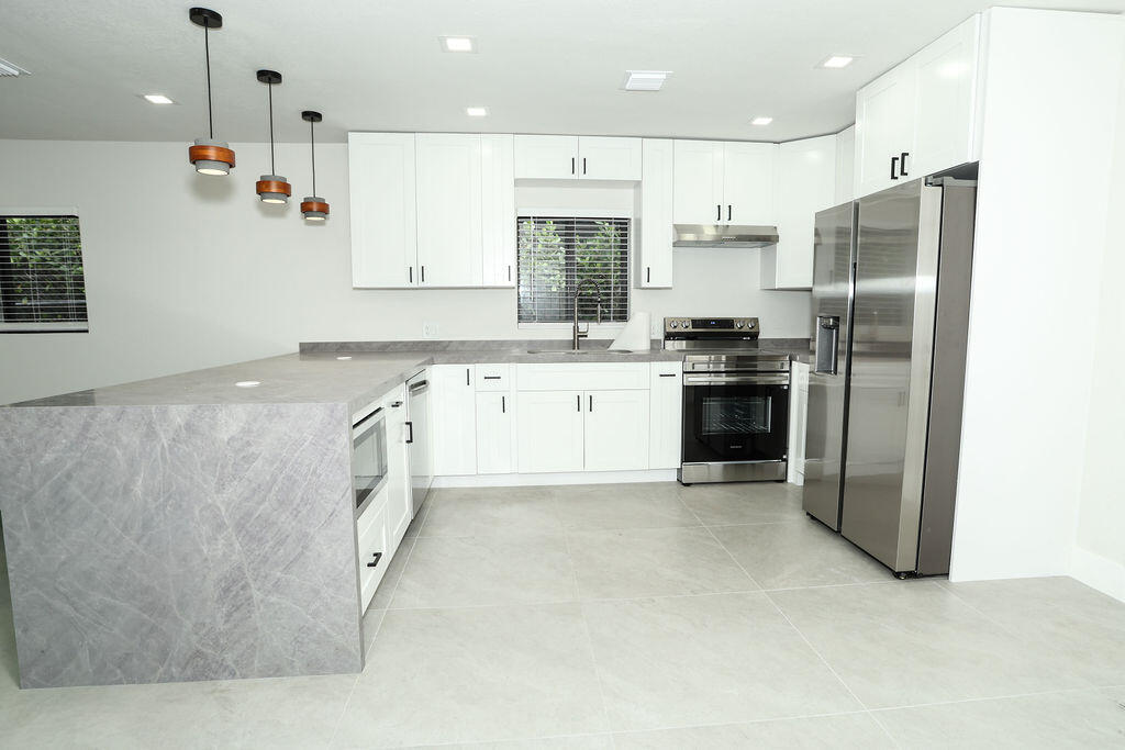 Welcome to a beautifully renovated gem in Miami Gardens, where modern upgrades meet comfort and convenience. This move-in-ready 3-bedroom, 2-bathroom home has been fully updated with a new roof, impact windows and doors, and stylish finishes throughout. The standout 520-square-foot primary suite offers a true retreat, featuring a massive custom walk-in closet and a spa-like bathroom with a separate shower and soaking tub.  The heart of the home is the open-concept kitchen, designed for both everyday living and entertaining, complete with sleek quartz countertops and modern appliances. Natural light flows effortlessly through the living spaces, creating a bright and inviting atmosphere. Located near highways, night life and restaurants. **$5000 SELLLER CREDIT**