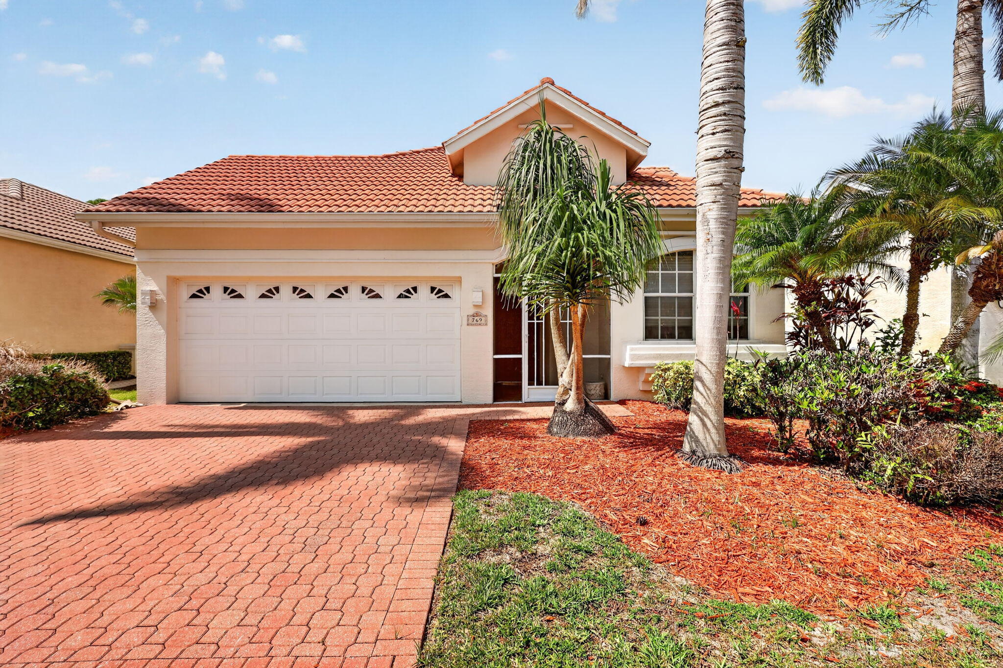 Pool home with a private courtyard design in the gated community of Lake Charles in the heart of St. Lucie West. This beautifully maintained 3-bedroom, 3-bath home offers true indoor-outdoor living with a unique layout designed for both privacy and entertaining. Step through the front entrance and into your own screened courtyard oasis featuring a sparkling pool surrounded by spacious entertaining areas, creating the perfect setting for relaxing, hosting guests, or enjoying Florida living year-round. The thoughtfully designed split floor plan includes a separate guest or in-law suite located across the courtyard with its own private bath, ideal for visitors, multigenerational living, or a private home office setup. Inside the main home, you'll find comfortable living spaces filled with  natural light and views of the courtyard pool from multiple rooms. The layout seamlessly connects the indoor and outdoor spaces, making the home feel open, airy, and inviting throughout. Recent updates include a new AC installed in 2024, new stove and washing machine, pool pump, motor, and timer replaced in April 2026, and a 2018 water heater. The exterior has been painted within the last five years, while the courtyard and rear lanai were freshly painted in 2024. Complete hurricane shutters provide added peace of mind. Beyond the courtyard, enjoy an additional screened rear lanai overlooking a private preserve backdrop with no rear neighbors, offering a peaceful and private setting. Located close to I-95, shopping, dining, golf, and medical facilities, this home combines convenience with the lifestyle and amenities Lake Charles is known for. Rarely do courtyard pool homes with this level of privacy and flexible living space become available.