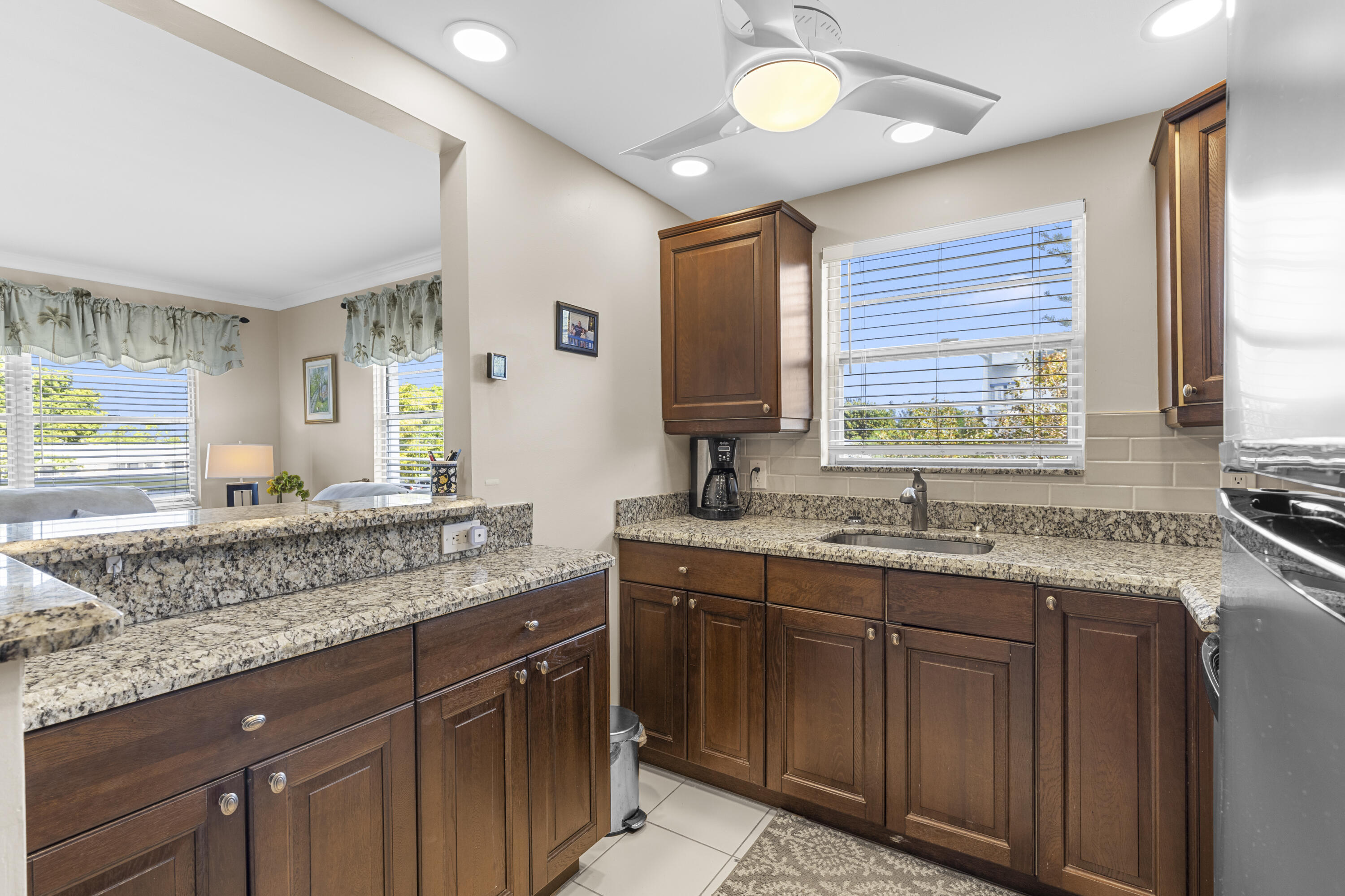BACK ON MARKET DUE TO BUYER'S FINANCE - Stunning corner unit 1-bedroom, 1.5-bathroom featuring breathtaking lake views and hurricane-impact windows in the patio. Fully renovated with sophistication, this beautifully maintained, fully furnished retreat is the perfect escape from winter. Steps away from the clubhouse and all amenities, welcome to Century Village — South Florida's premier 55+ resort-style community! Enjoy an active lifestyle with amenities including a clubhouse, tennis courts, billiard room, art classes, fitness center, local bus service, and so much more. Just minutes from the beach, restaurants, and shopping. South Florida living at its finest — this one is a must-see! Rentable building.