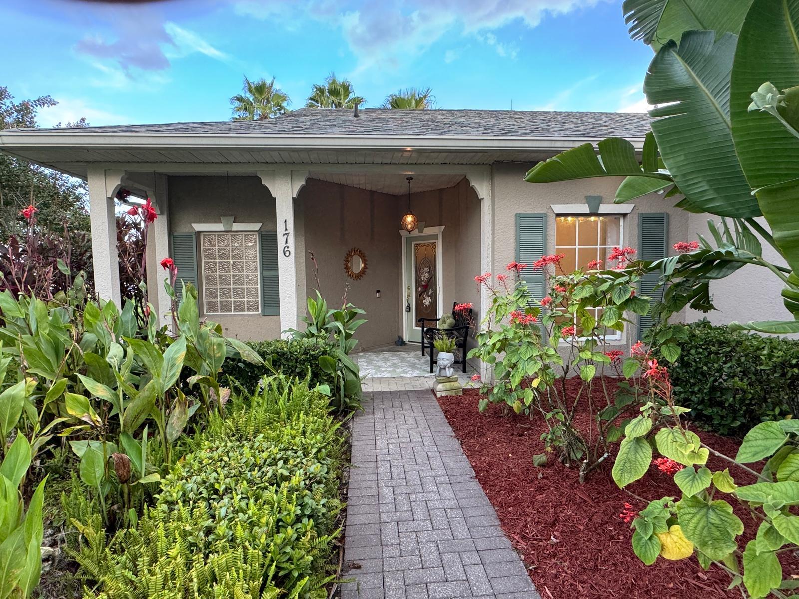 100% Designer Remodel! New flooring, cabinets, lighting, tile, paint, trim, kitchen & baths! HUGE corner lot with the nicest neighbors.Water views & moon views from the glass conservatory overlooking a 122' garden. Designer kitchen has new floating shelves & cabinets with quartz countertops & NEW appliances. The 6 person seating peninsula will be the center of this entertainer's dream home. Custom tile work. Feature walls in the den, living room and master bedroom. New garage epoxy floor.Butcher block laundry folding counter. Phantom screen on the stain glass front door & retractable canopy over the back patio.  Enjoy the restaurants, gym, active life style in the golf course & nature community of gated Solivita!