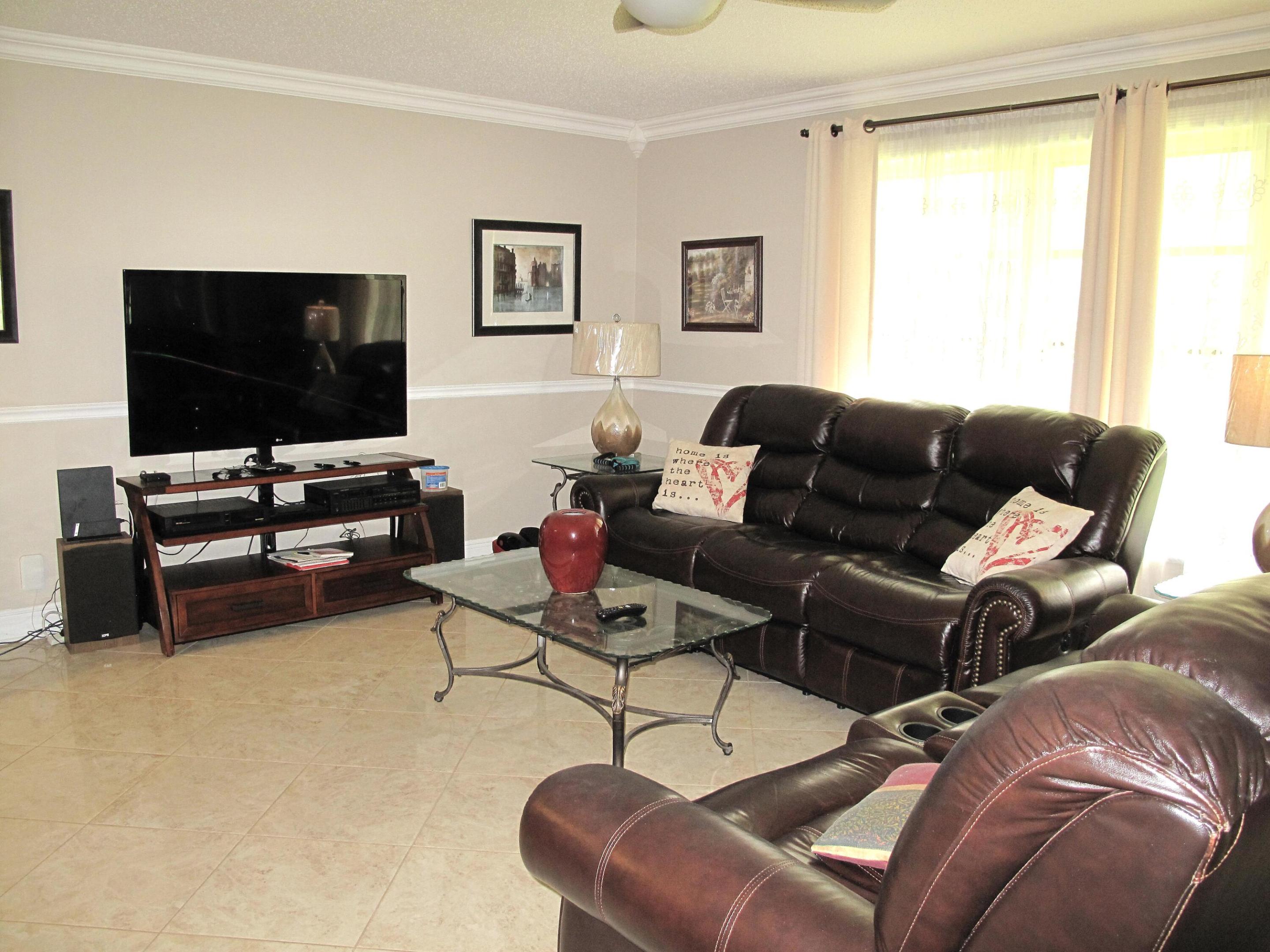 Welcome to Your Piece of Paradise! Discover this beautifully maintained 2-bedroom, 2-bath corner villa nestled in a vibrant 55+ community. This inviting home offers comfort, convenience, and the best of Florida living. Offered turnkey/furnished. Step inside to find a bright, updated kitchen featuring white cabinetry with convenient pull-out drawers, a spacious pantry, newer appliances, a large stainless-steel sink, and stylish faux-granite countertops. Neutral tile flooring runs throughout the home, creating a clean and cohesive look. Enjoy added living space in the enclosed, air-conditioned Florida room—perfect for a den, office, or relaxation area. The home also features crown molding and updated baseboards in the main living areas, adding a touch of elegance.  Enjoy added living space in the enclosed, air-conditioned Florida room—perfect for a den, office, or relaxation area. The home also features crown molding and updated baseboards in the main living areas, adding a touch of elegance. Step outside to your private rear patio, ideal for BBQs and entertaining guests. Community Amenities Include: Heated resort-style pool, Clubhouse with planned social activities, Shuffleboard. Conveniently located just minutes from the beach and downtown Delray, you'll have easy access to charming shops, open-air cafés, fine dining, entertainment, and major highways, including I-95 and the Turnpike. Additional features include a shared coin-operated washer and dryer for each building of four villas.  All information is deemed reliable but not guaranteed and subject to change without notice.