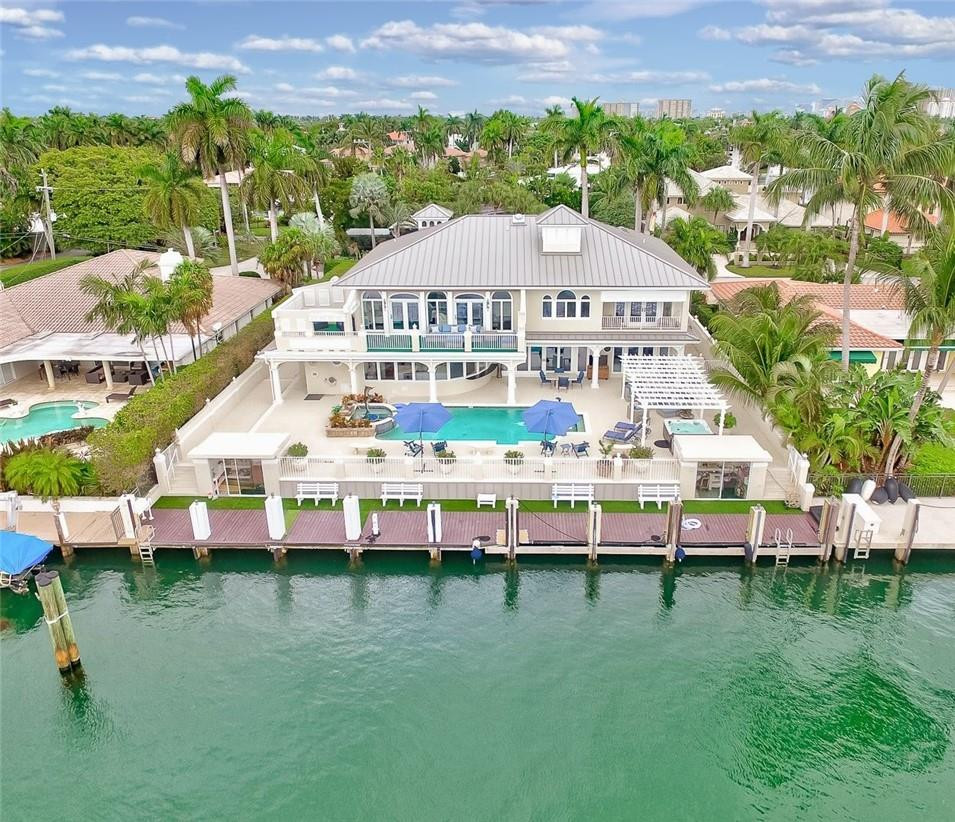 A beautiful transition from Mediterranean to a sophisticated Key West inspired home in the most desirable community in Ft. Lauderdale; Harbor Beach! Located on a 150’ ± WIDE DEEPWATER CANAL/95’ ± FT OF WATERFRONT. 6 Bedroom + Den + Office! So many upgrades including new metal roof, dock, AC’s, kitchen, doors & more. This magnificent residence is truly move-in ready with two master suites, one conveniently located on the first floor overlooking the waterfront and the other featuring a large private balcony w/electric retractable shade. Enjoy hot tub, pool, full steam shower while entertaining friends & family. True Captain and Maid's Quarters w/separate garage entry into main house. 3 car garage and excess storage off the dock. A must see! Voluntary HOA includes private beach access for Harbor Beach Residents Only! Furniture is negotiable.