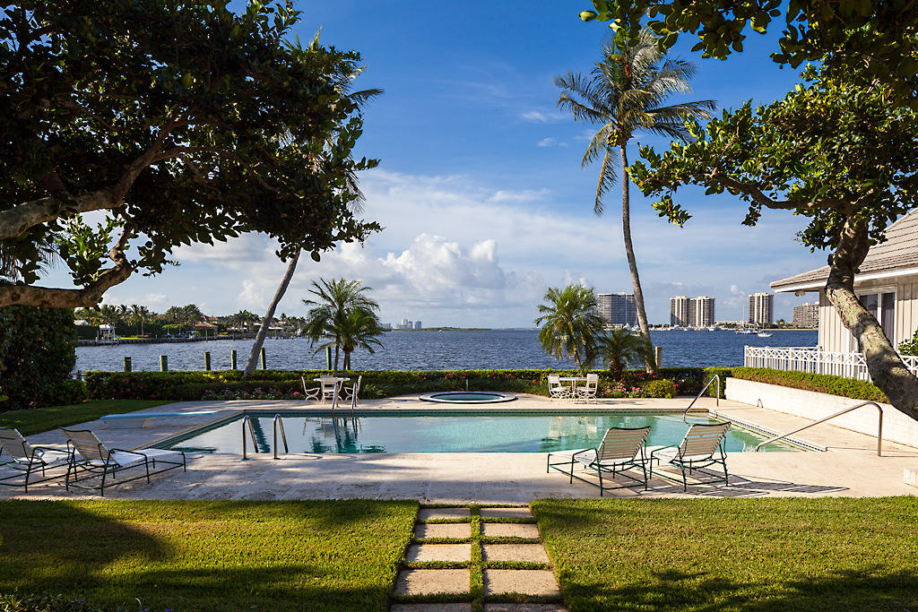 This property with unmatched views of Lake Worth & deep water dockage for a yacht in excess of 100 ft., is arguably the finest opportunity in the area.  The spacious, 2-story home has 5 bedrooms, a maid’s quarters with full bath, & a one bedroom pool house.  The glass enclosed loggia offers a large open sitting area with spectacular water views, along with casual dining perfect for enjoying a relaxing lunch overlooking the terrace & sparkling pool. Two gracious living rooms provide ample space to entertain or enjoy a game of bridge with friends.  The formal dining room is just off the kitchen & pantry area. The property is located in one of the most exclusive private communities in Florida which offers golf, tennis, a state-of-the-art fitness facility, private beach & first class security.