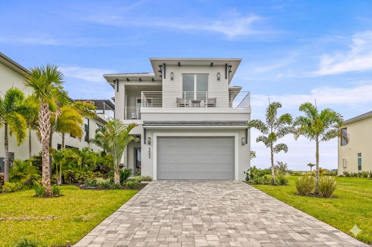 Welcome to the exquisite coastal-style home situated in the highly sought-after Laguna Village directly on the Intracoastal/Indian River within prestigious Grand Harbor. This brand new construction offers the ultimate in luxury and comfort, with direct riverfront views and an impressive 4 bedrooms, 4 full bathrooms, and 2 half bathrooms. The al fresco riverfront kitchen is perfect for entertaining guests and enjoying outdoor meals while taking in the breathtaking river views. Sip your coffee & watch the sunrise from your riverfront lanai complete with summer kitchen, fire pit and fire features & putting green.   With over 3,786 square feet of air-conditioned living space and a total of over 5,000 square feet, this 2-story home is designed to exceed your expectations.  Built with the utmost attention to detail, this home features 12 foot ceilings in the living spaces and 10' ceilings upstairs. The open floorplan kitchen features custom cabinetry and a spacious island. The private dining room is complete with a walk in wine vault with cold storage for 150 bottles and dry storage for 130 more.  The primary suite is complete with a spacious bath, huge shower and soaking tub with spectacular river views. The custom walk in closet has a large island. Its best feature is a large covered patio with river views for miles. The concrete block construction, a durable metal roof, impact glass windows, and icynene insulation provide optimal energy efficiency and safety. For added convenience, an elevator is included, providing easy access to all levels of the home. The custom garage by Obsessed Garage provides ample space for your vehicles and storage needs.  This is coastal living at its finest, where every detail has been carefully considered to create a truly exceptional living experience. Indulge in the resort-style amenities that Laguna Village at Grand Harbor has to offer, including 2 world class golf courses, safe harbor marina, tennis, pickle ball, luxury clubhouse w/ dining, oceanfront beach club and the new state of the art 15,000 sq ft Cove wellness and fitness center. Immerse yourself in the natural beauty of the surrounding landscape, with lush greenery and serene waterways at your doorstep.