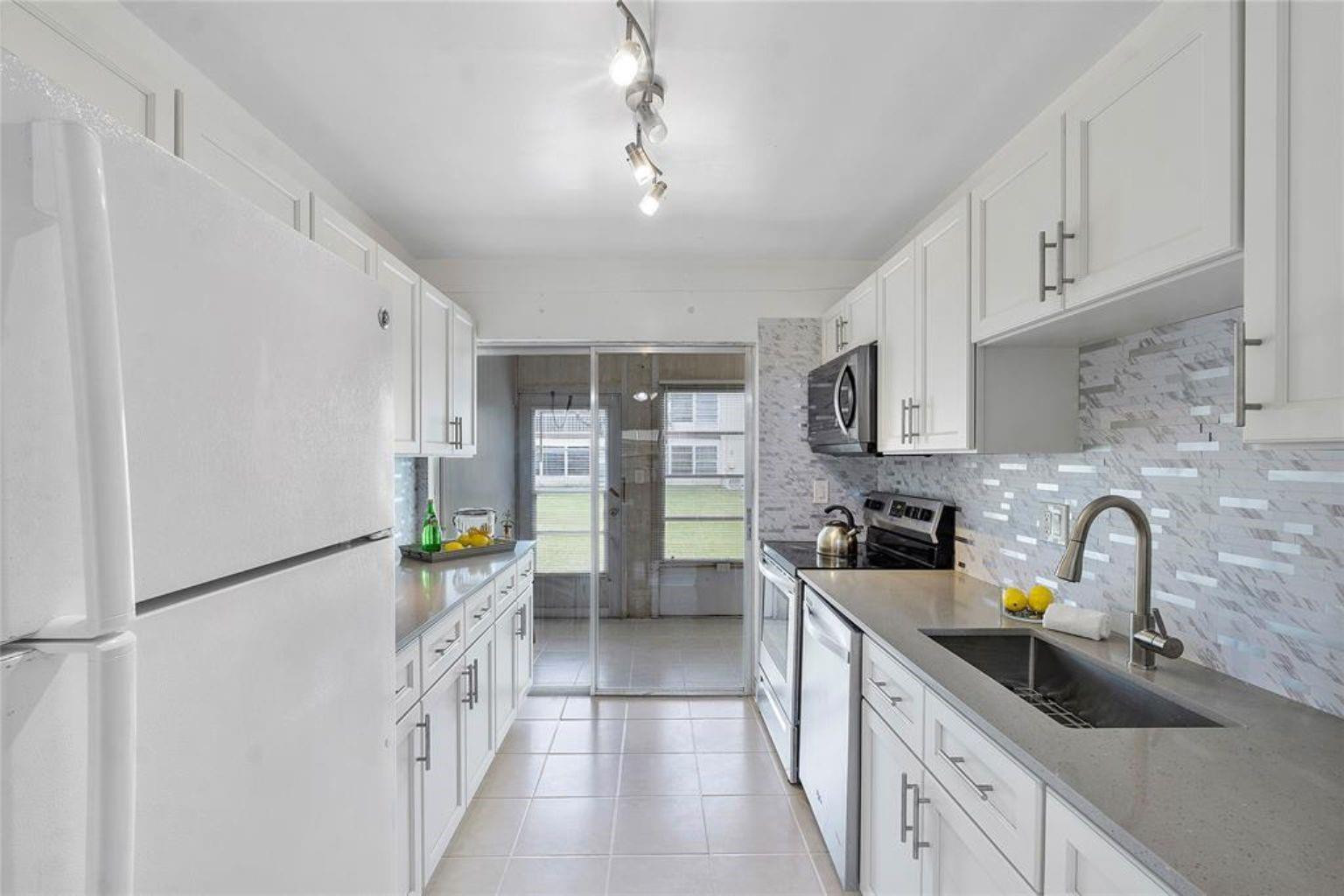 Seller Financing Option is Available! Updated w/ exquisite finishes! Beautiful, bright, & spacious 1st Floor Condo in highly sought-after Oriole Gardens! This spacious 1BD 1BA condo have new wood cabinets, quartz counters, refinished tile floors throughout, & laminated floors in the bedroom! Lots of natural light, a priv. screened patio overlooking wide garden views. Conveniently located near the clubhouse & pool. Next door to common Laundry & Storage room. Assoc. requirements include: 55+ comm., a min. cred. score of 675, no pets allowed, buyer min. inc. of $35K/year, 20% down payment for financed purchases, & no renting allowed during the 1st 3 yrs. Tenant Occupied until 6/30/2026! The community offers a wide range of amenities: a clubhouse, exercise room, pool, & scenic walking trails++