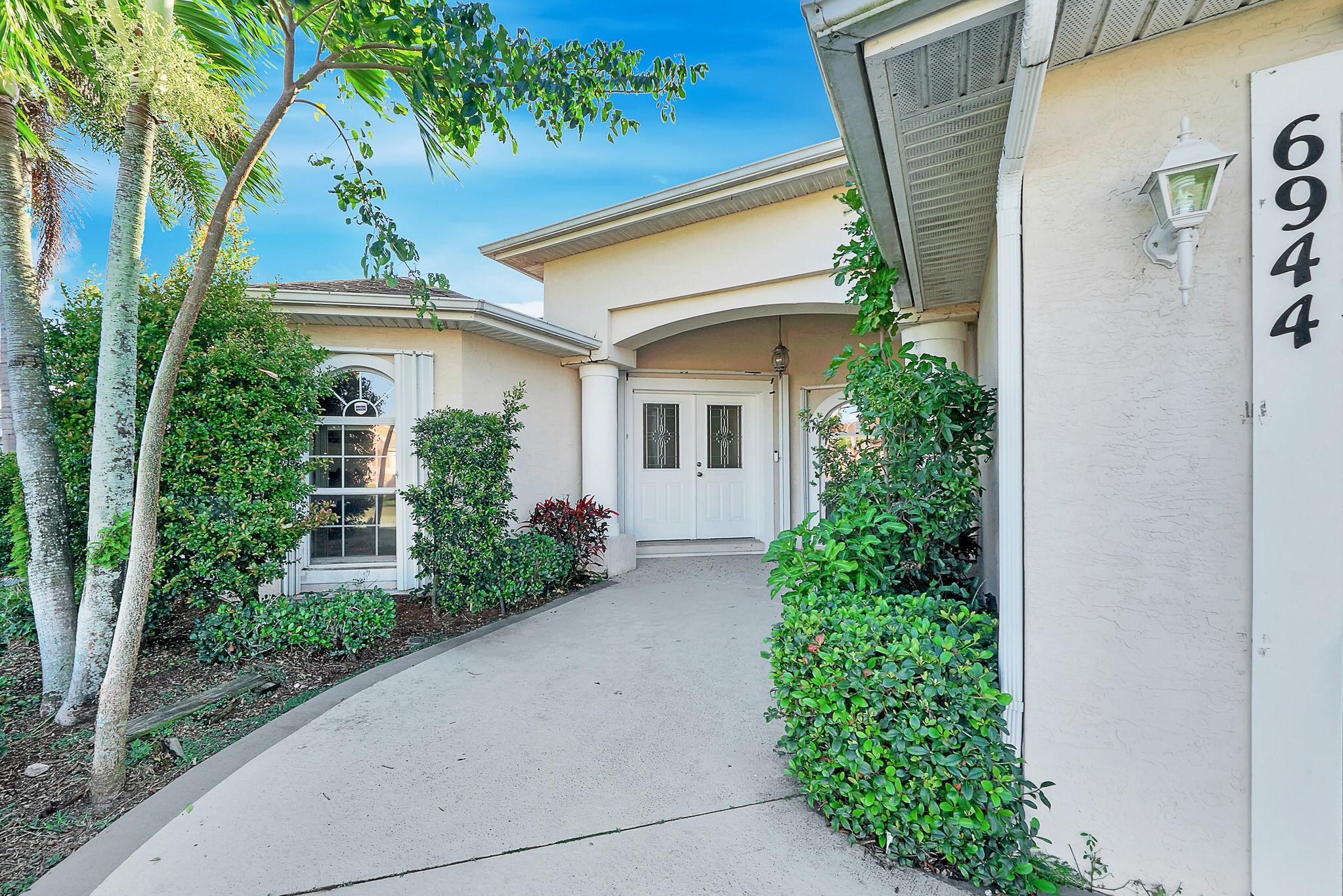 Spacious and well-designed 4-bedroom, 3-bath home with a 3-car garage.  This triple split-bedroom layout offers privacy and flexibility, featuring a formal dining room plus separate living and family rooms ideal for everyday living and entertaining. Enjoy Florida living on the enclosed patio with hot tub that conveys. Main bathroom includes a walk-in tub for added comfort and convenience. No HOA. ****4 point inspection attached