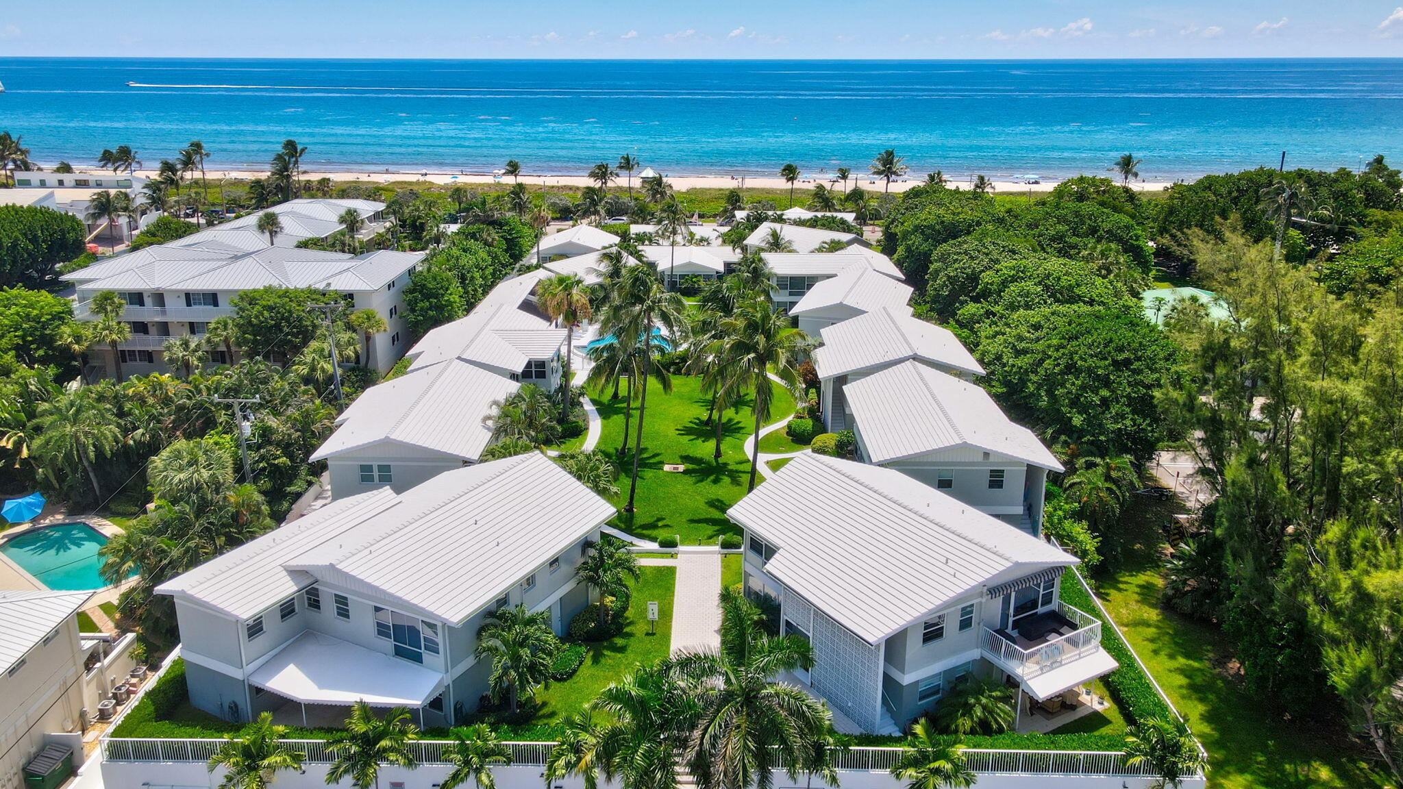 This exceptional property presents a rare opportunity to own a masterfully reimagined residence, showcasing an unpresented level of luxury and design entirely new to the exclusive Lanikai Villas community, in the beach and Atlantic Ave district. The developer and designer spared no expense, delivering a complete one-of-a-kind villa with finishes typically reserved for luxury estates. Inside, the sophisticated design showcases European white oak flooring, custom cabinetry and woodwork, elegant wallpaper, and designer lighting. The gourmet kitchen features Bosch appliances and stunning Brazilian quartzite countertops, complemented by an entertainment bar. Impact glass.  The villa has light from all four sides, with tropical landscape views. Separate private storage attached to your building and garage storage. Discover the charm of pet-friendly Lanikai Villas, offering garage parking, a heated pool, clubhouse, and a cabana complete with a full kitchen and grill—perfect for entertaining while overlooking beautifully landscaped tropical grounds.  Make this your home or home away from home.  This is a rare opportunity to own a true coastal gem.