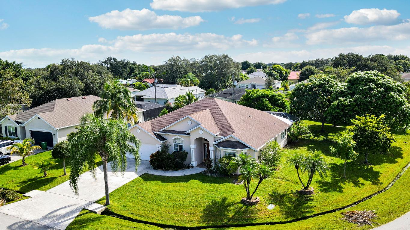 Motivated Sellers have priced their home below market value! This gorgeous 4bdr/3ba home is impeccably maintained and perfect for entertaining. It is tiled throughout with a spacious formal living room, dining room and office w/French doors. It has a large Family room, breakfast nook with elec. fireplace, and an inviting kitchen w/granite countertops, center island and SS appliances. Enjoy your privacy within a huge covered/screened patio, w/travertine flooring and a summer kitchen with serving counter, gas range cook top, sink and refrigerator. The home enjoys full sprinkler system and mature landscaping as well as full hurricane shutters. To top it off, a new roof was just installed Sept. 2025!! This home is a must-see for buyers looking for a quality-built custom that has it all!!