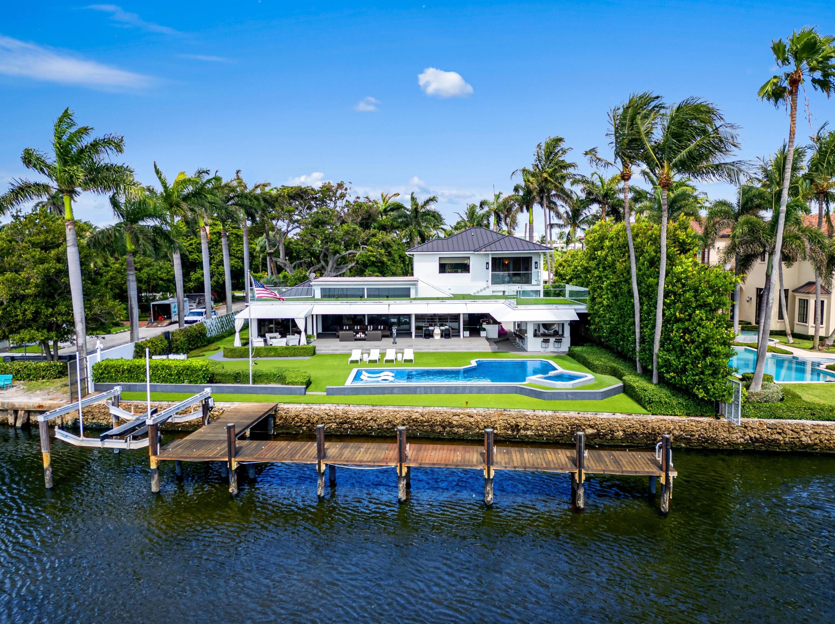 A unique waterfront opportunity awaits — build a new 20,000-square-foot estate or enjoy as is! On nearly a half-acre on a corner parcel with 103+/- feet of wide direct Intracoastal Waterway frontage, astute owners can create the mansion of their dreams with a versatile floor plan tailored to fit their needs and superb yacht dockage in one of Delray Beach's most desirable neighborhoods. LOCATION:   201 Palm Trail, Delray Beach, Florida: The desirable Palm Trail neighborhood is perfectly located, just minutes from Delray Beach's award-winning sand-carpeted beaches, as well as vibrant Atlantic Avenue's boutique shopping, dining and nightlife venues. It is barely 20± minutes from Boca Raton's private executive airport, and an easy 30± minute commute to Palm Beach International Airport.  PROPERTY:    This incredible property, as a buildable lot, offers a rare and unique waterfront opportunity to build a new-construction, 20,000-square-foot estate. On nearly a half-acre on a corner parcel measuring 103 by 175 feet with 103 feet of wide direct Intracoastal Waterway frontage, astute owners can create the mansion of their dreams with a versatile floor plan tailored to fit their needs and superb yacht dockage in one of Delray Beach's most desirable neighborhoods.  RESIDENCE:   Build new or enjoy as is! Masterful modern design with a dramatic flair stages the scene for sophisticated waterfront living in this magnificent Palm Trail estate sited on nearly a half-acre along a wide expanse of the Intracoastal Waterway. Airy spans of glass bathe the interiors with natural light, while sleek stone finishes and gleaming stainless-steel accents juxtapose with exotic woods and oversized black Kertile flooring to create a comfortable living environment that presents as a work of art. Lush landscaping and water views are integral focal points, with major rooms arranged around expansive waterside terraces that edge the geometric reflective pool. Immediately beyond the entry's shimmering metal double doors, sweeping water views unfold in the intimate sitting area and chic living room where an entire wall of pocketing glass sliding doors topped by clerestory windows offer Intracoastal views. Seamlessly blending indoors and out, the dining room features three walls of sliding glass doors offering water views. The adjoining gourmet kitchen   equipped with contemporary high-gloss white cabinetry, quartz counters, high-end GE Monogram appliances, a pantry and breakfast area  opens outside to the outdoor summer kitchen. Other major rooms are just as stunning. The family room is finished with custom cabinetry surrounding the 120-inch TV, while a 700-bottle temperature-controlled wine room adds drama and function. Additional spaces include an office, gym, two guest bedrooms, laundry, cabana bathroom and the three-car garage. Upstairs, the primary suite opens to a private water-view balcony. The suite comprises two bathrooms that share a central walk-through shower, and a standout design detail: one of the bathrooms features a soaking tub with a ceiling-mounted rainfall tub filler. Two ensuite guest bedrooms and a stackable laundry station complete this level.   Modern comforts about: an elevator, natural-gas accommodation, 60 kW Generac whole-house generator, impact-rated windows and doors, metal roof, three 5-ton air conditioners (all within 5 years old), two tankless gas water heaters, a half-house water purifier, reverse osmosis water system in the kitchen, and central vacuum system. Showcasing high design, resort-caliber amenities, and 103± on the Intracoastal, this is an entirely unique estate in a sought-after location offering the best of the Delray Beach lifestyle.    The information herein is deemed reliable and subject to errors, omissions or changes without notice.  The information has been derived from architectural plans or county records. Buyer should verify all measurements.   DISCLAIMER: Information published or otherwise provided by the listing company and its representatives including but not limited to prices, measurements, square footages, lot sizes, calculations, statistics, and videos are deemed reliable but are not guaranteed and are subject to errors, omissions or changes without notice. All such information should be independently verified by any prospective purchaser or seller. Parties should perform their own due diligence to verify such information prior to a sale or listing. Listing company expressly disclaims any warranty or representation regarding such information. Prices published are either list price, sold price, and/or last asking price. The listing company participates in the Multiple Listing Service and IDX. The properties published as listed and sold are not necessarily exclusive to listing company and may be listed or have sold with other members of the Multiple Listing Service. Transactions where listing company represented both buyers and sellers are calculated as two sales. "No payments made until title passes" Some affiliations may not be applicable to certain geographic areas. If your property is currently listed with another broker, please disregard any solicitation for services. Information published or otherwise provided by seller, listing company or its representatives is deemed reliable but are not guaranteed and subject to errors, omissions, or changes without notice. Copyright 2024 by the listing company. All Rights Reserved.