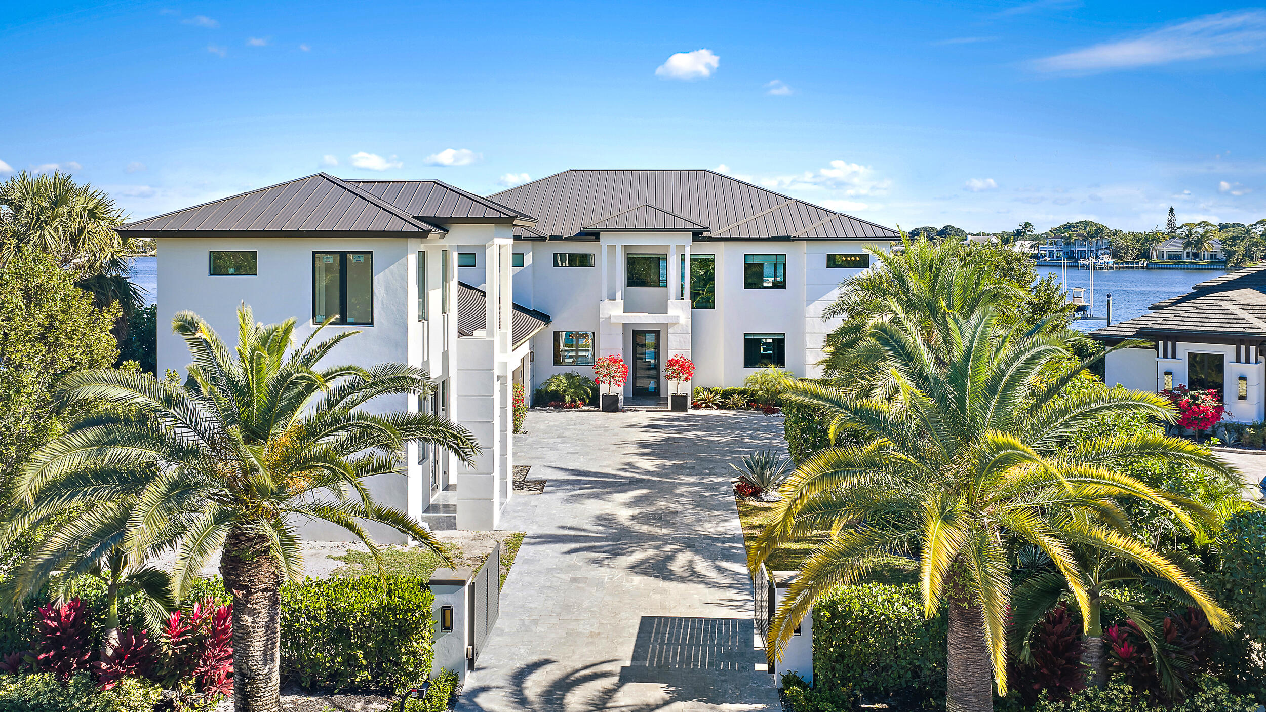 Waterfront estate home built in 2022, ideally positioned on a quiet street with fewer than ten homes and offering some of the most impressive views Jupiter has to offer. Designed with sleek, modern architecture, the residence is complemented by a separate guest house, providing flexibility for visitors, extended family, or a private office. Enjoy true waterfront living with a 50,000-lb boat lift and direct ocean access right from the backyard. Perfectly situated near Jupiter's iconic sandbars, waterfront restaurants, and everything the area's famous waterways have to offer. The outdoor living space is designed for year-round enjoyment, featuring a resort-style pool and spa, expansive turf areas, multiple fire pits, and an exceptional summer kitchen with a gazebo—creating the ideal setting for entertaining or relaxing in complete privacy. Seamless indoor-outdoor flow enhances both functionality and livability throughout the home. The primary suite will blow your mind, featuring expansive custom closet space, sweeping views looking the full length of the river, and an incredible primary bathroom that completes the experience. A rare opportunity to own a newer construction waterfront estate offering privacy, modern design, breathtaking views, and immediate access to the Jupiter lifestyle.