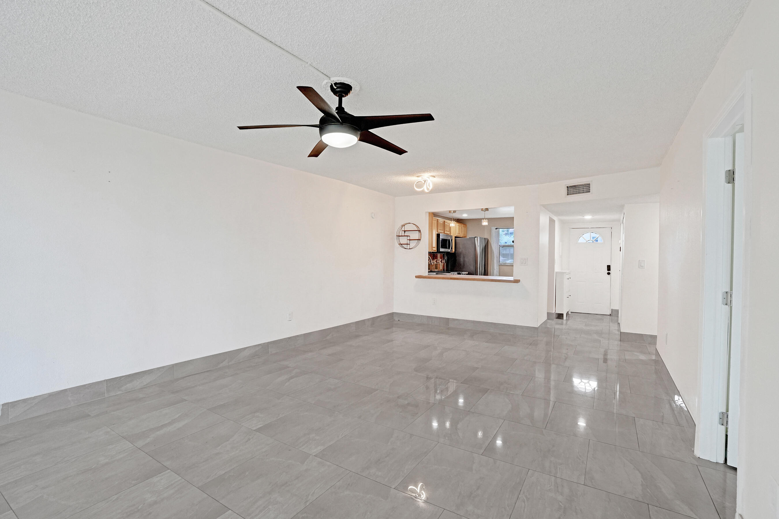 Beautiful 2 bed/ 2 bathroom first-floor condo with serene golf course views. This spacious and sleek unit features tile flooring and updated bathrooms. The primary suite offers a walk-in closet and a beautifully renovated bath with a glass-enclosed walk-in shower. The kitchen features stainless steel appliances (2023), and the water heater was replaced in 2023. New fans and light fixtures throughout add a modern touch. Enjoy relaxing on the screened patio overlooking the golf course. Community amenities include a pool, tennis courts, on-site laundry facilities, and additional storage. Includes 1 assigned parking space plus guest parking. Special assessment will be paid in full at closing. Clean, quiet, and move-in ready!