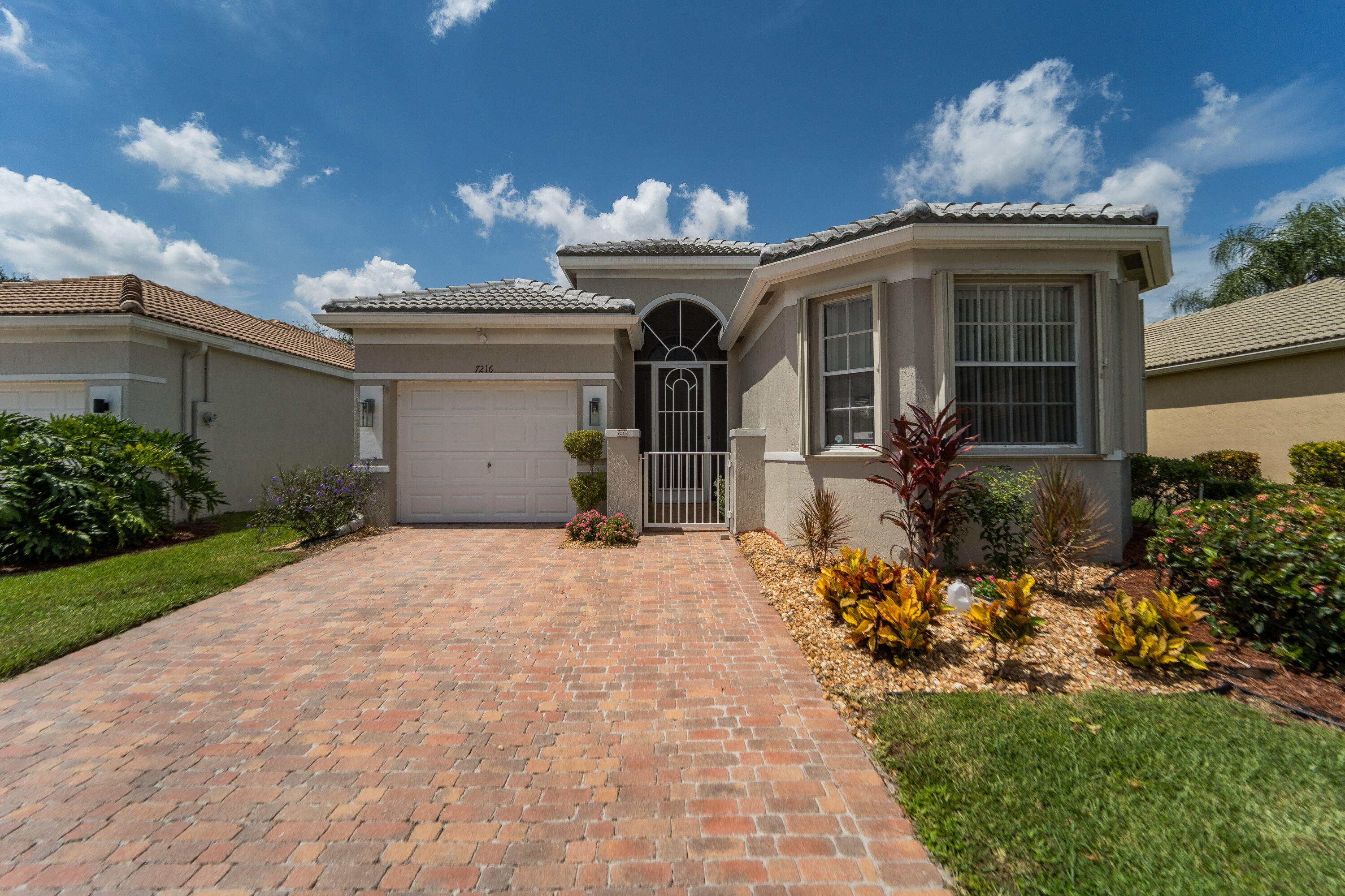 Lake Views | New 2024 Roof | 2020 A/C | Gated Vizcaya Community Beautifully maintained lakefront home featuring a desirable split-bedroom floor plan with vaulted ceilings and an open layout. Recent updates include a new $40,000 roof (2024), 2020 A/C, freshly painted interior and exterior, brand-new carpet in the bedrooms and den, newer refrigerator, washer and dryer, updated exterior lighting, and an upgraded guest bath. Additional highlights include a double-door den, breakfast bar, extended screened patio, accordion hurricane shutters, closet organizers, Nest thermostat, and a UV HVAC air purification system. Located in the gated community of Vizcaya with 24/7 manned security and resort-style amenities. Use main entrance on Atlantic Ave for gate access