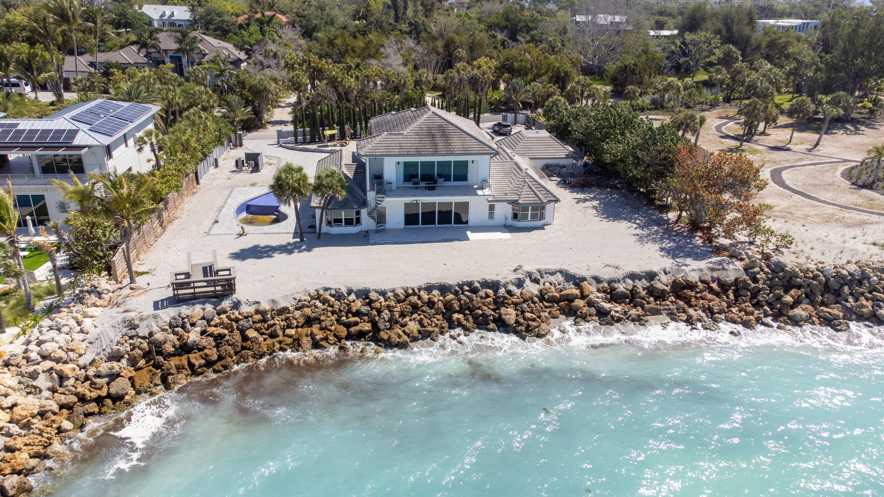 Experience coastal luxury at its finest at 7816 Sanderling Road, an exceptional residence nestled within the prestigious Sanderling Club on Siesta Key. Perfectly positioned in one of Sarasota's most exclusive beachfront communities, this property offers private beach access, unparalleled water views, timeless architecture, and a serene Gulf Coast setting.  Set on an expansive 0.8-acre homesite, the residence spans approximately 4,015 square feet and features 4 bedrooms and 4 bathrooms. Originally built in 1970, the home has an effective year built of 2015, reflecting significant updates and enhancements, including the addition of the entire second story in 2018.  Designed to embrace indoor-outdoor living, the home captures beautiful Gulf views while offering spacious living and entertaining areas. Major improvements include a new roof (2021), updated HVAC system (2024), and electrical and plumbing updates completed in 2024. The property also includes a generator for added peace of mind. The pool,  rebuilt in 2019, remains in working condition following the hurricane, complementing the lush tropical landscaping and outdoor living spaces.  The second story showcases the home's newer construction, while the first floor presents a rare opportunity for customization—allowing a buyer to bring their own vision to life and complete renovations to their exact specifications. This flexibility creates a unique value-add opportunity within a premier location.  Just moments from the powdery sands of Siesta Key Beach, this is a rare chance to secure and personalize a luxury coastal retreat in one of Florida's most sought-after beachfront enclaves.