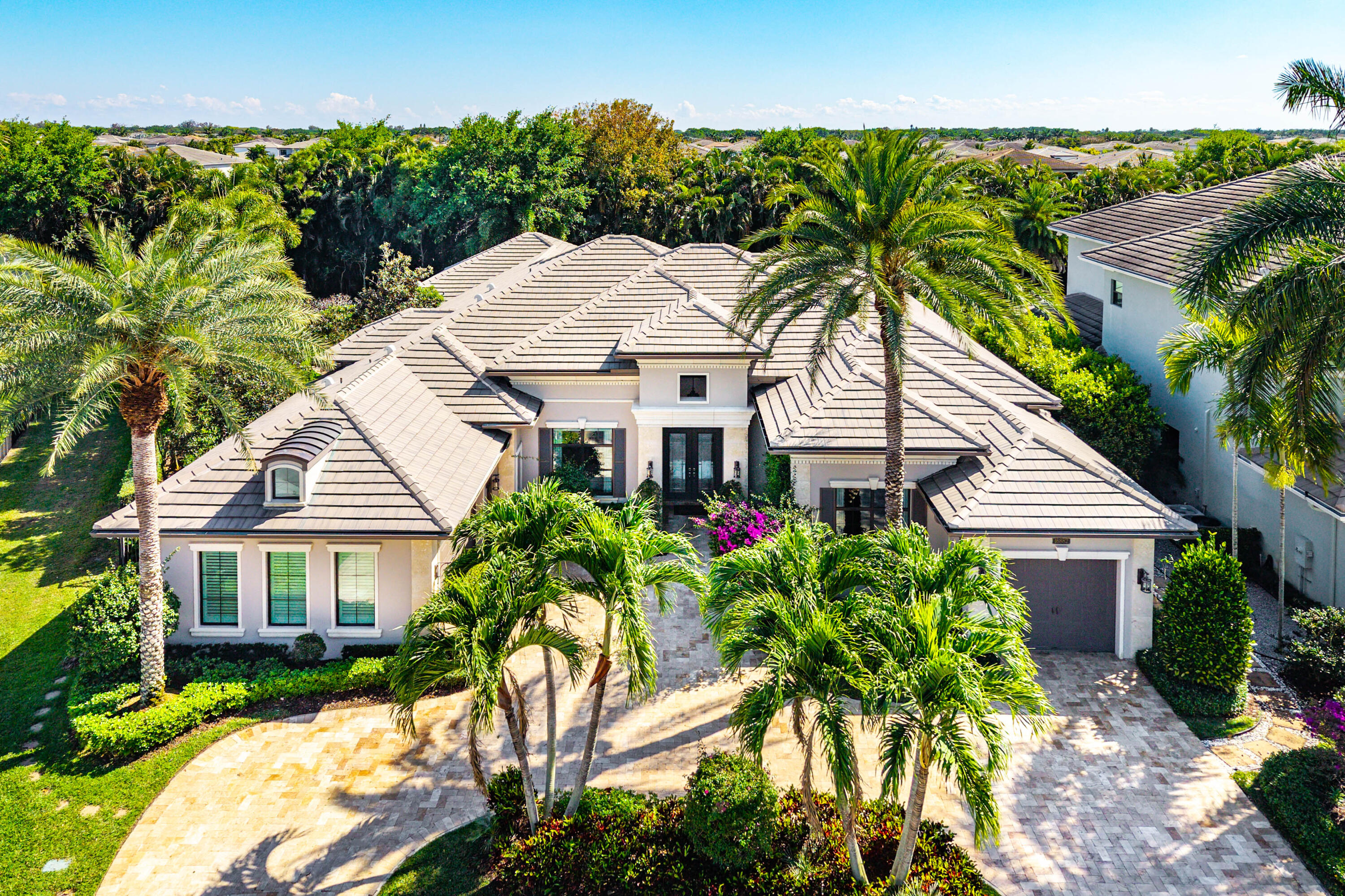 Luxury. Lifestyle. Location. Whether you're searching for the perfect year-round residence or an exceptional seasonal retreat, this stunning custom one-story estate offers a rare opportunity to own one of the finest homes in The Bridges, one of Boca Raton's most prestigious resort-style communities. Spanning over 4,844 square feet, this meticulously customized residence blends timeless elegance with modern luxury. At its heart is a spectacular chef's kitchen featuring custom stacked cabinetry, premium Sub-Zero stainless steel appliances, under-cabinet lighting, marble countertops, designer tile backsplash, and a spacious center island—perfect for entertaining or everyday living. The luxurious primary suite is a private sanctuary, highlighted by a dramatic coffered ceiling, dual spa-inspired bathrooms, oversized walk-in closets, and every comfort imaginable. A dedicated in-home fitness room offers the convenience of maintaining your wellness routine without ever leaving home. Step outside to your own private resort. The breathtaking backyard showcases a covered lanai with a custom wood-paneled ceiling, a fully equipped summer kitchen with granite countertops, and a heated pool and spa designed for relaxing, entertaining, and creating unforgettable memories year-round. No detail has been overlooked. Additional highlights include a richly appointed executive office with custom wood paneling, elegant marble flooring with granite inlays, designer ceilings, striking glass entry doors, a fireplace, whole-home audio system, separate drip irrigation, lush professional landscaping, epoxy-finished garage floors, and the ultimate peace of mind—a whole-house backup generator that keeps your home running no matter the weather. Living in The Bridges means embracing a world-class lifestyle with an award-winning clubhouse, resort-style pool, tennis, pickleball, fitness center, on-site dining, and activities for every member of the family. Perfectly situated between Boca Raton and Delray Beach, you'll enjoy easy access to upscale shopping, fine dining, pristine beaches, major airports, and top-rated A-rated schools. Opportunities to own a home of this caliber in The Bridges are few and far between. Schedule your private tour today and discover why this extraordinary residence is the one you've been waiting for.