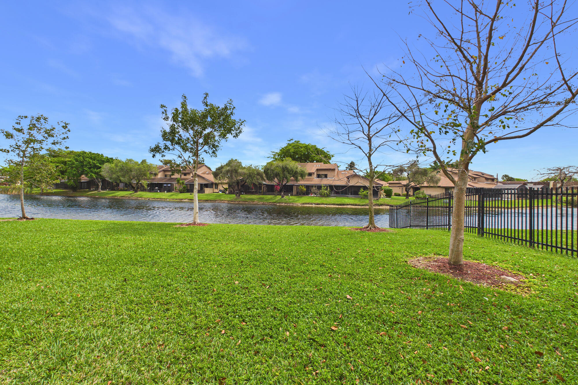 Don't miss this 3 bedrooms, 2 bathroom condo on the 1st floor with scenic lagoon views from the back patio! Wood plank ceramic style floors throughout. Master has two closets including a walk-in and an ensuite bathroom.  Accordion hurricane shutters on all windows and one assigned parking space with available guest parking. Residents  have access to the pool, gym, pickleball and tennis courts. Perfect for an investor or homebuyer!